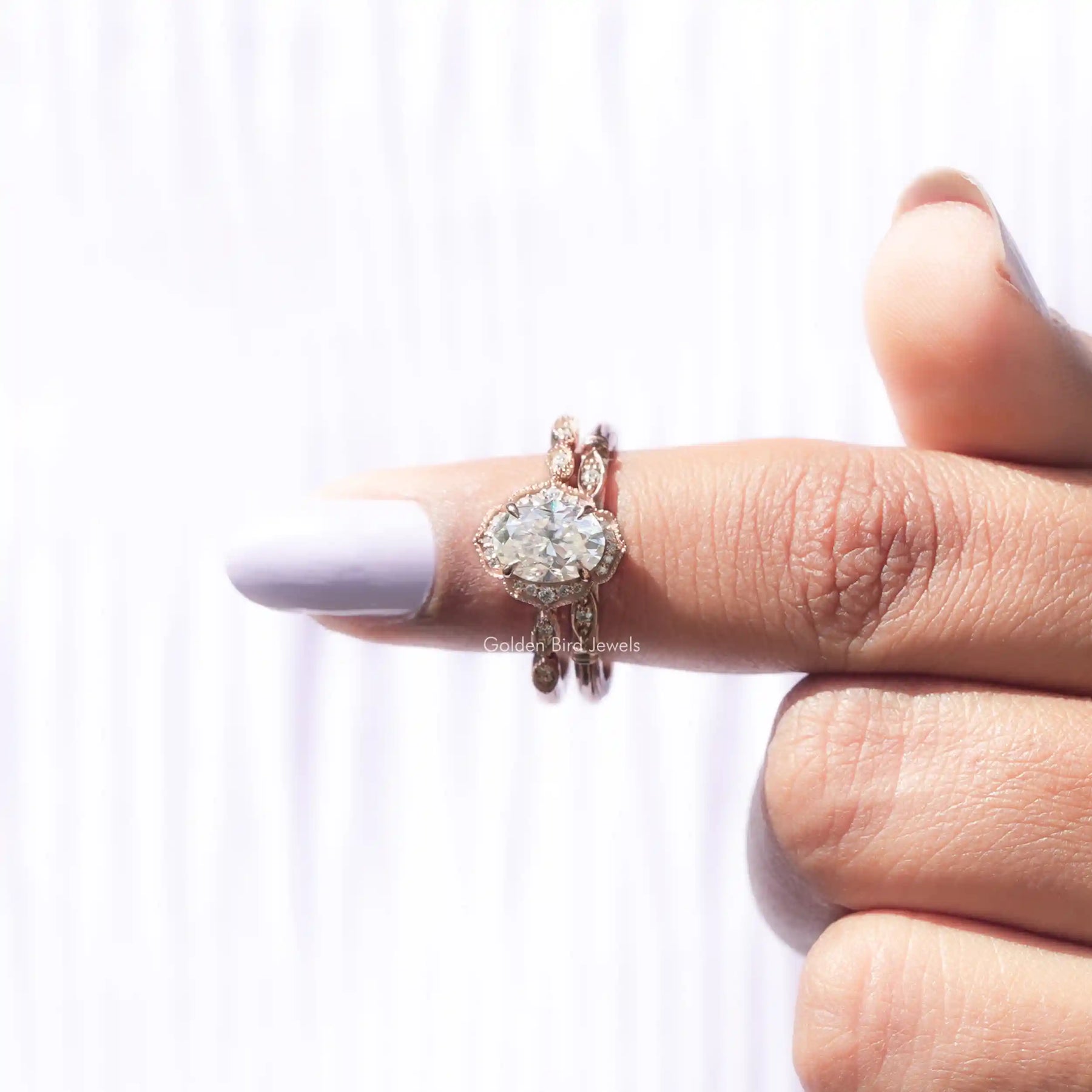In finger front View of Oval Cut Moissanite Halo Ring Set