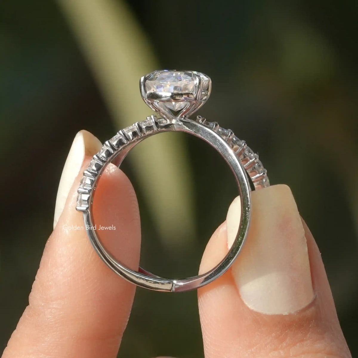 Back View of Oval Cut Split Shank Moissanite Ring In two fingers