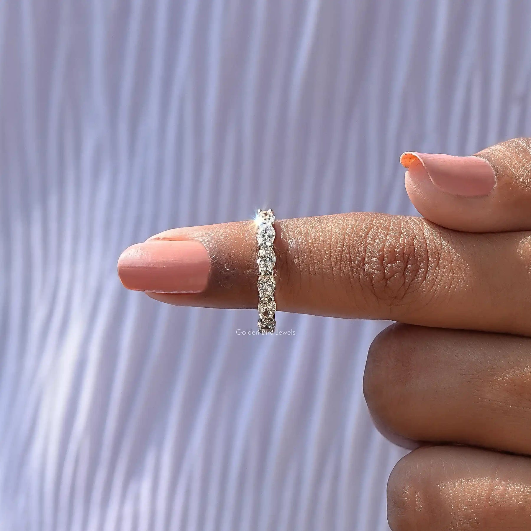 In finger front View of Oval Shape Diamond Eternity Wedding Band In White Gold