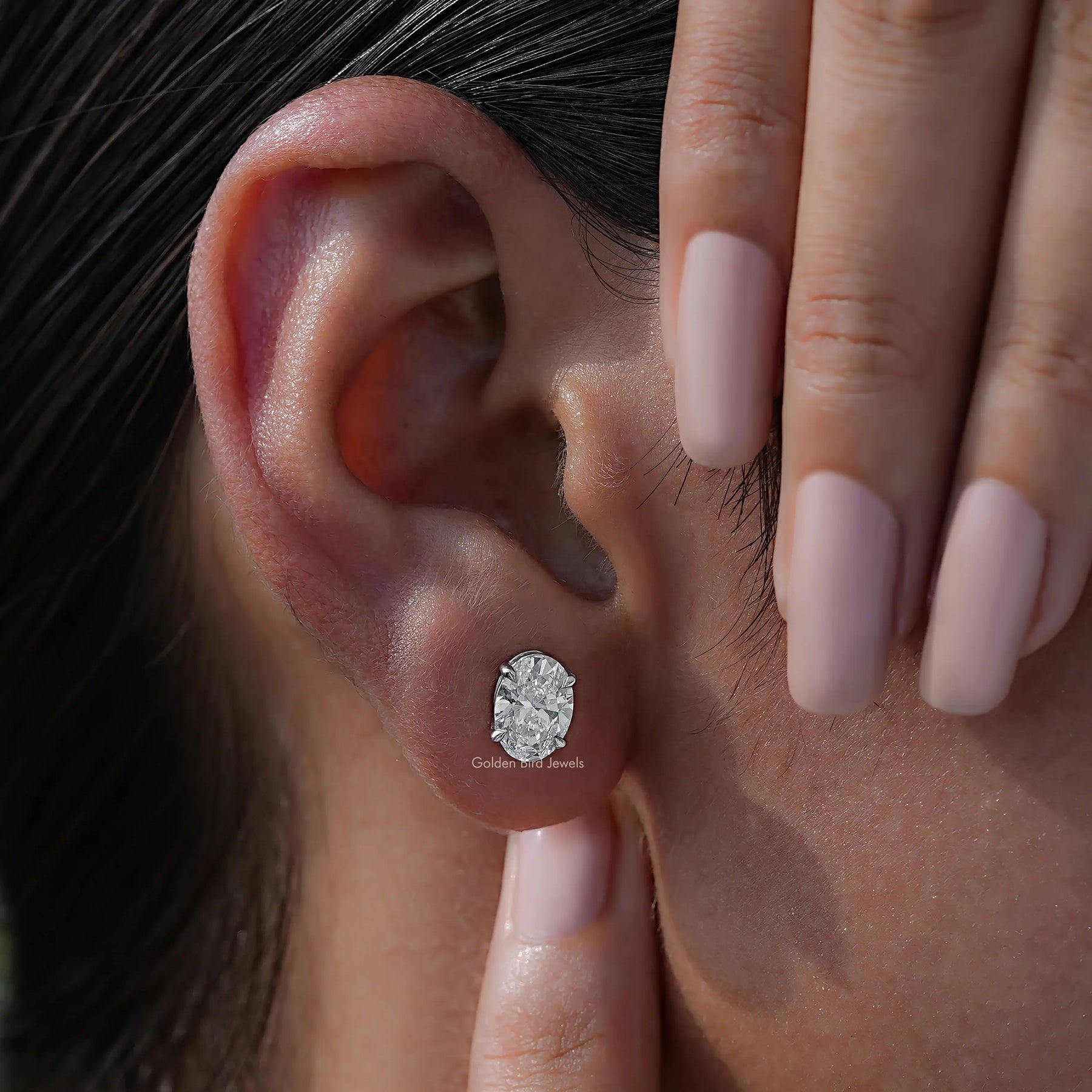 Detailed view of lab stud earrings in secure setting