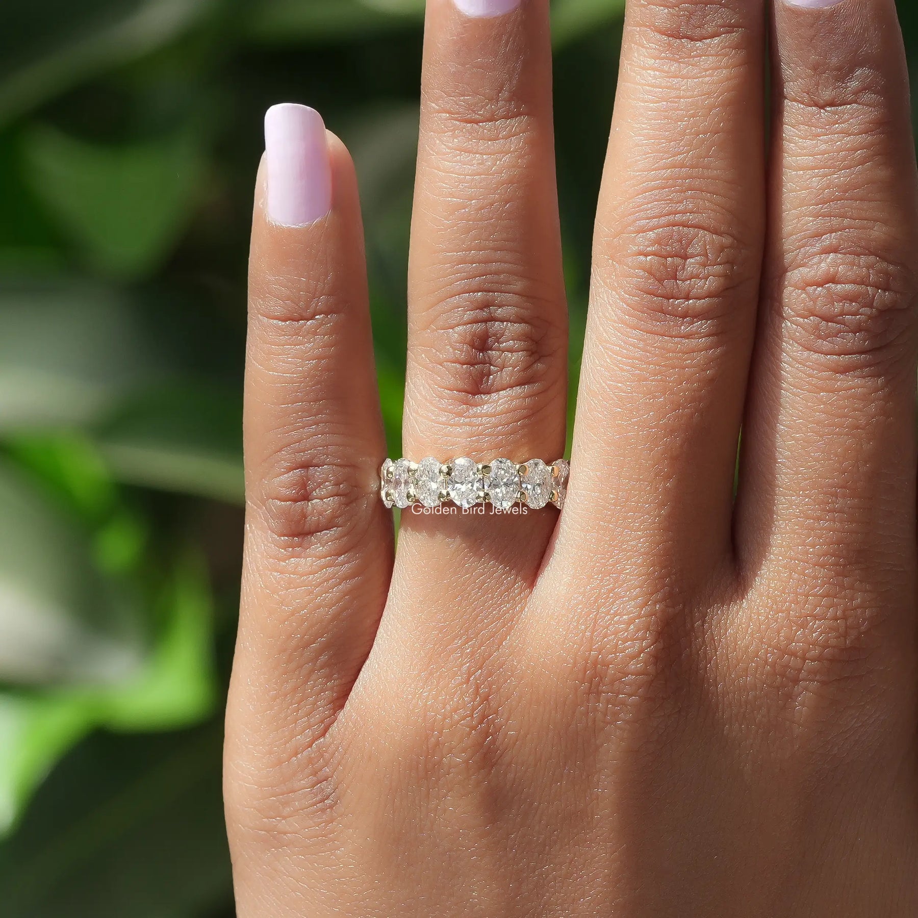 View of Oval Cut Lab Diamond Eternity Wedding Band In Finger