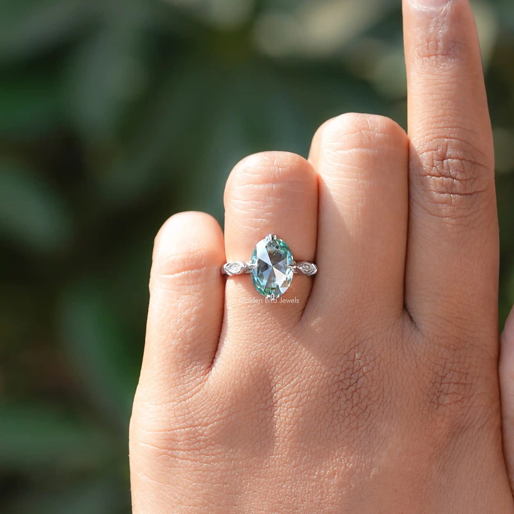 Front view of rose oval moissanite accent ring.