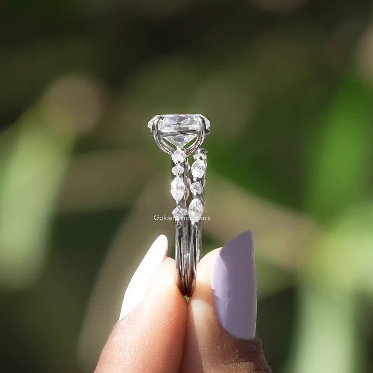 Side View of Oval Cut Moissanite Bridal Ring In two fingers