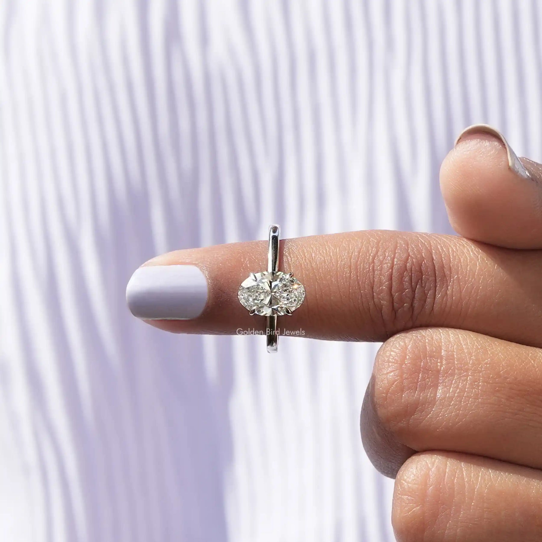 In finger front View of Oval Cut Diamond Solitaire Ring