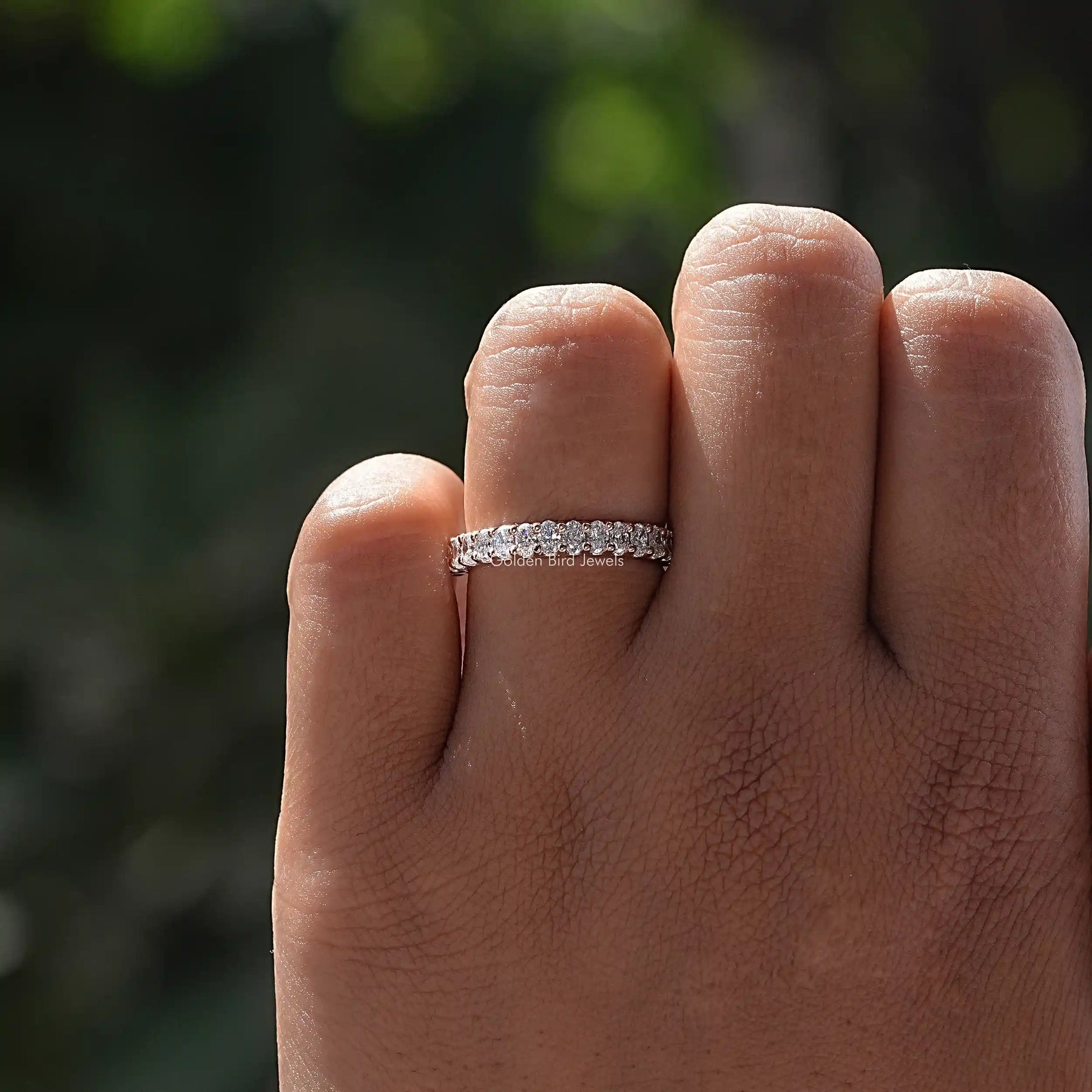 Close-Up View of Oval Cut Lab Diamond Wedding Band In Yellow Gold