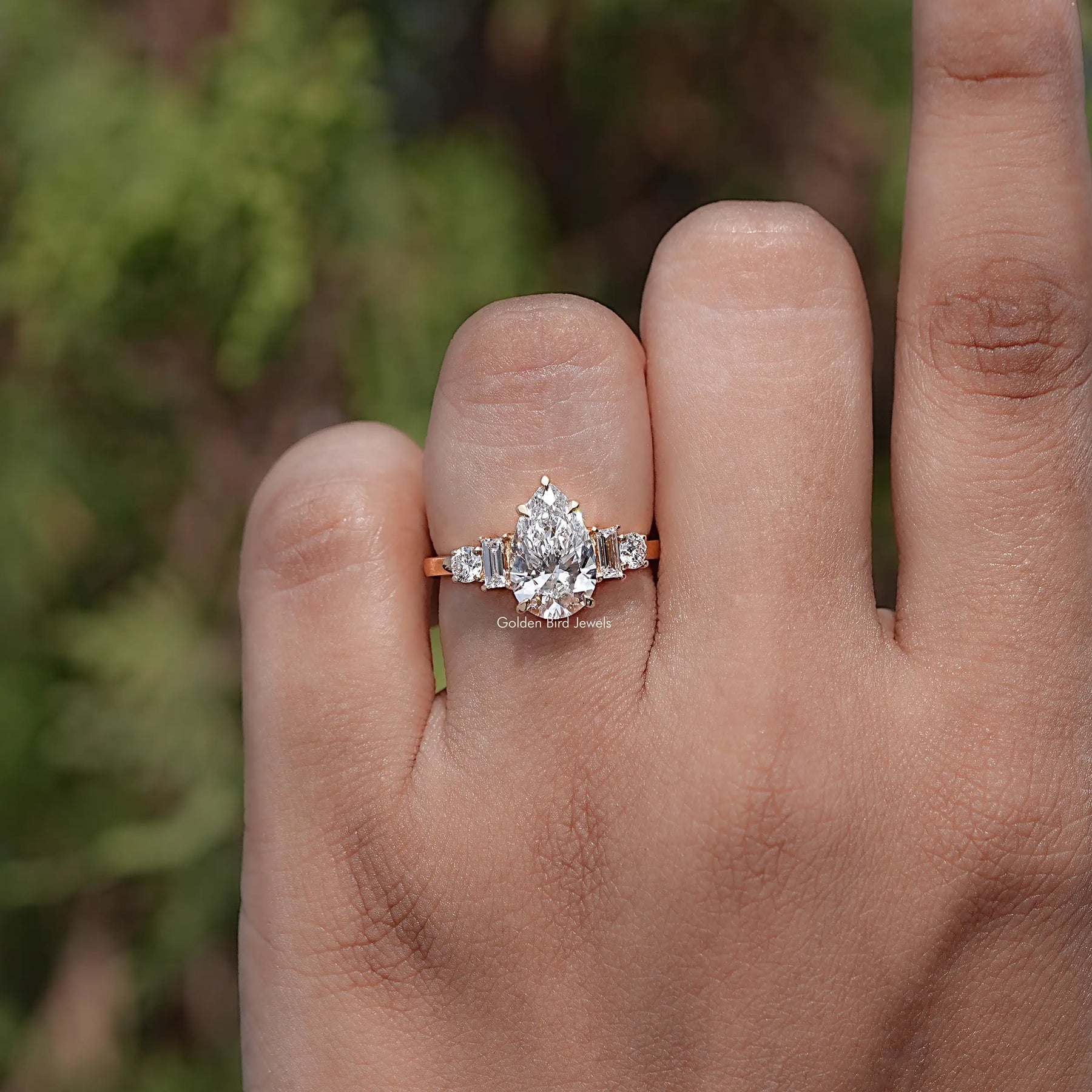 Front view of Pear And Baguette Cut Diamond Five Stone Ring