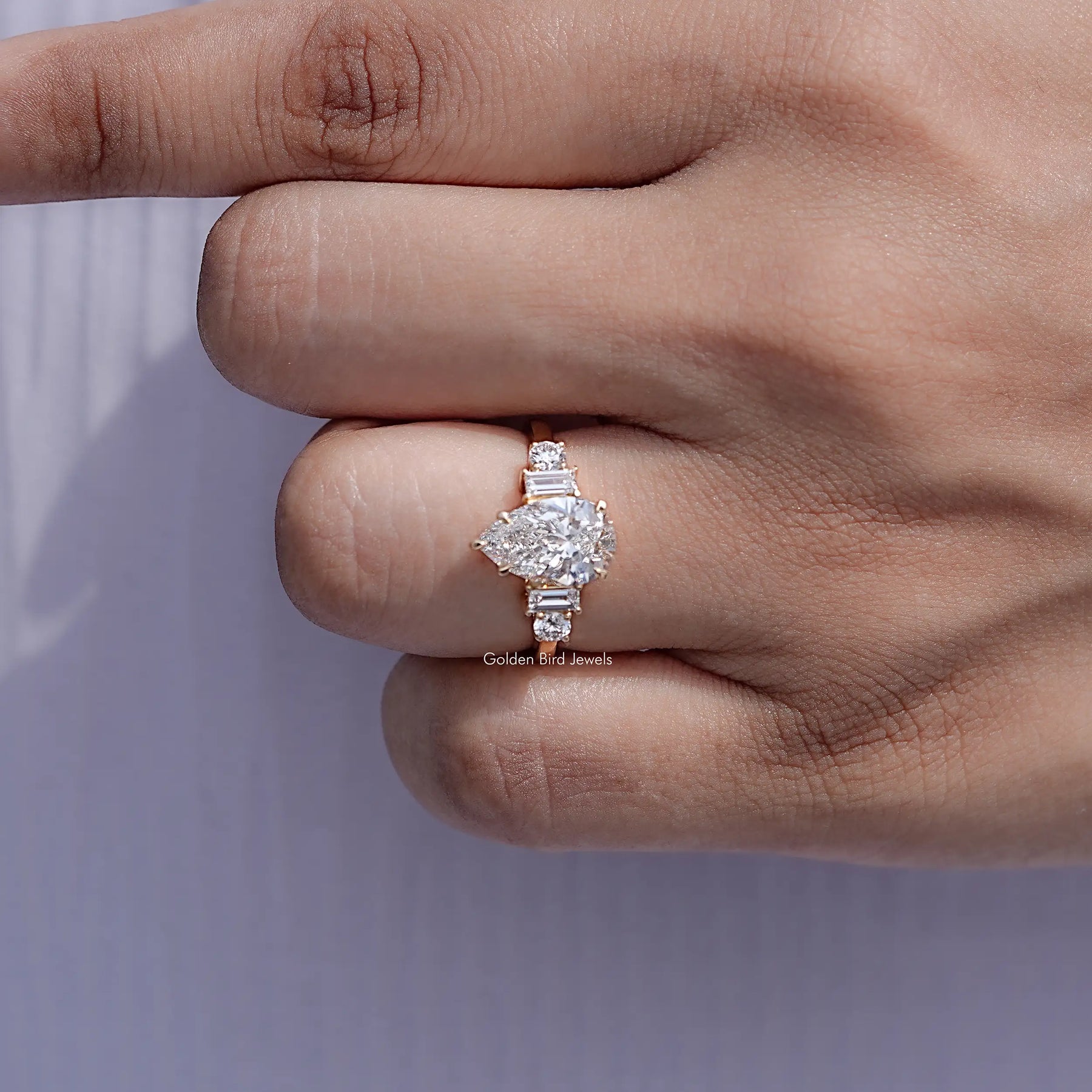 Detailed view of Pear And Baguette Cut Diamond Five Stone Ring