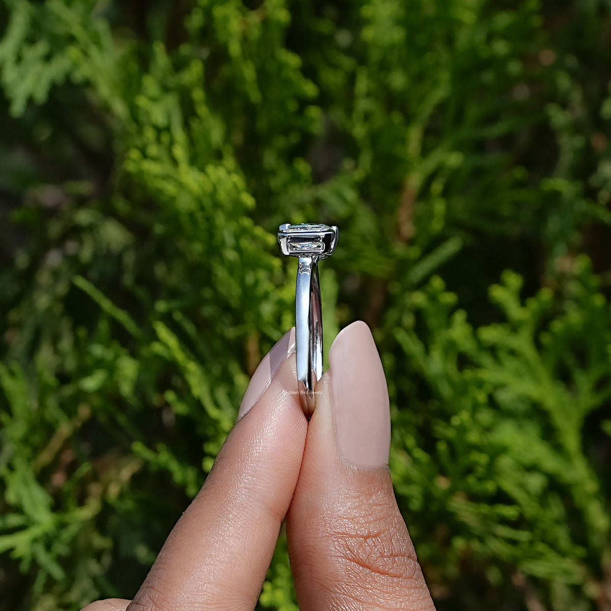 Side View of Pear And Radiant Cut Toi Et Moi Ring In two fingers