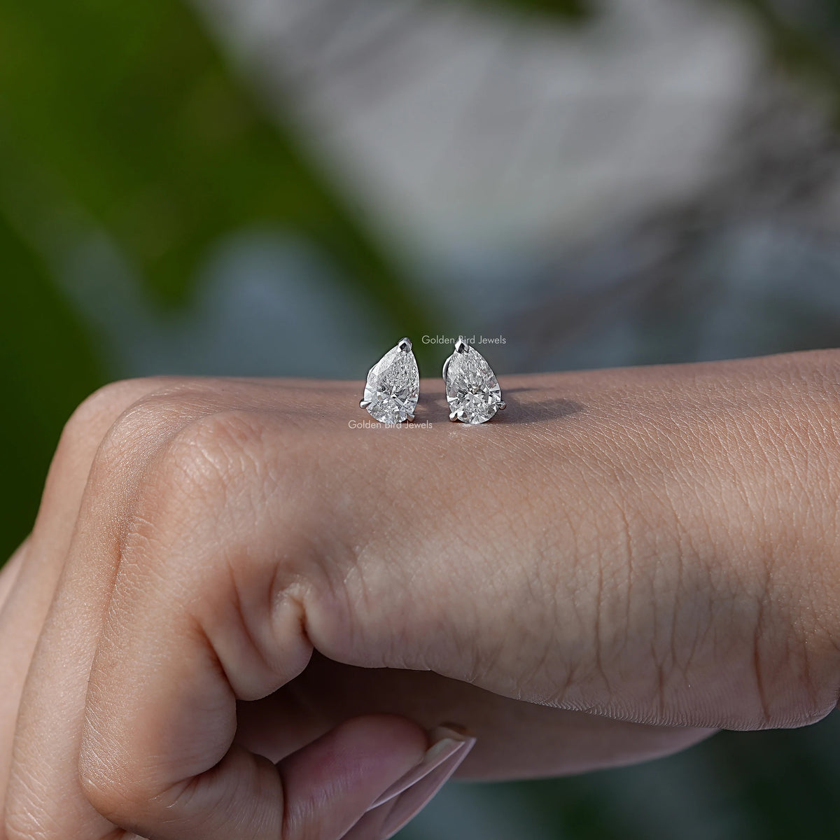 In Hand View Of 2CTW pear Cut Solitaire Stud Earring