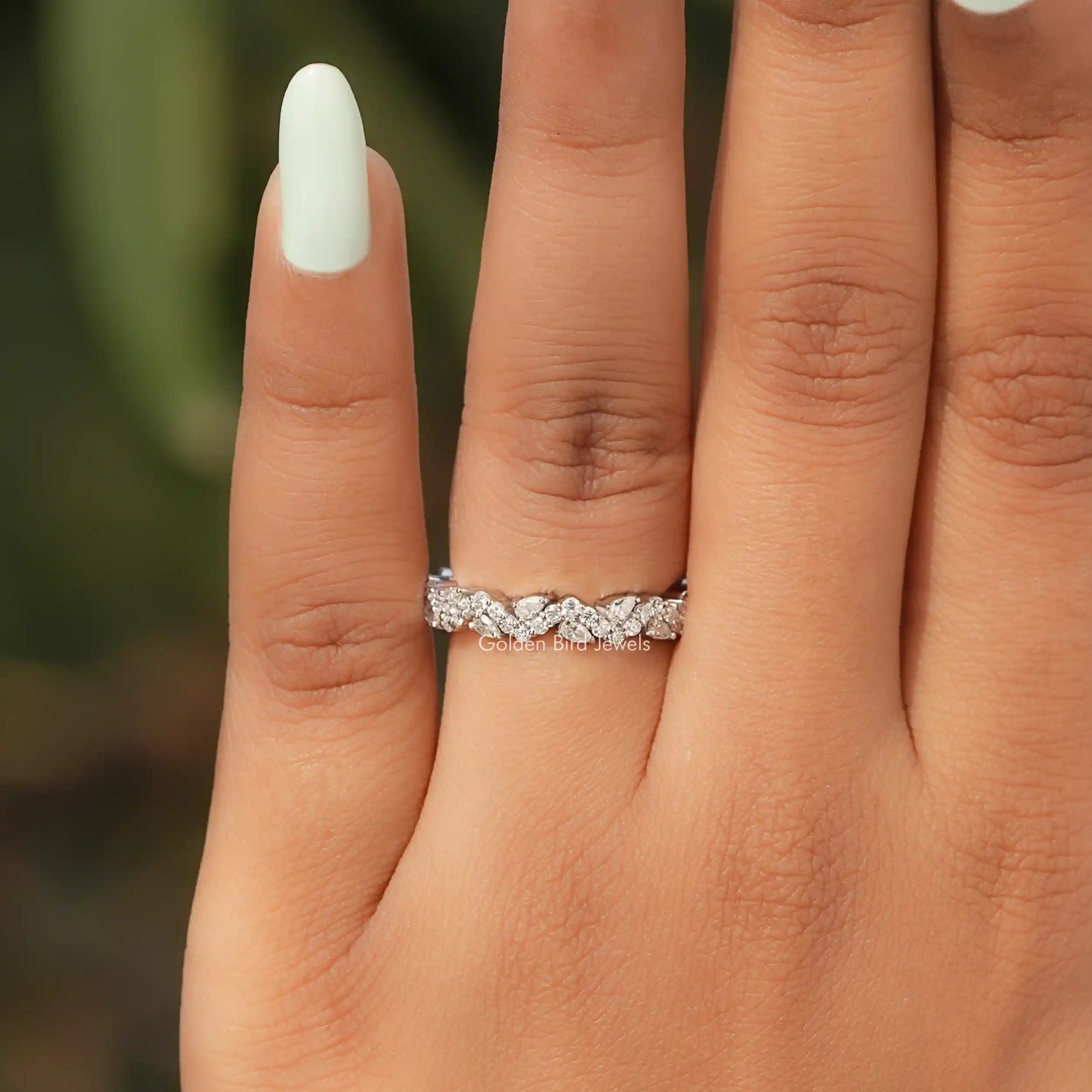 In finger view of Pear Shaped Solitaire Moissanite Ring
