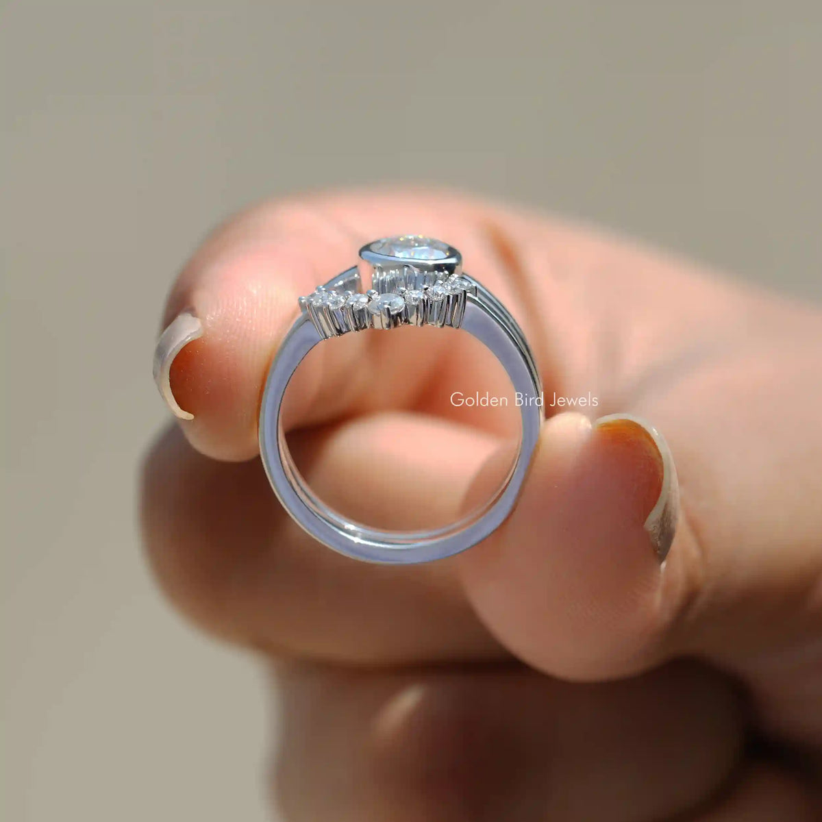 Back View of Pear Cut Moissanite Bridal Ring Set In two fingers