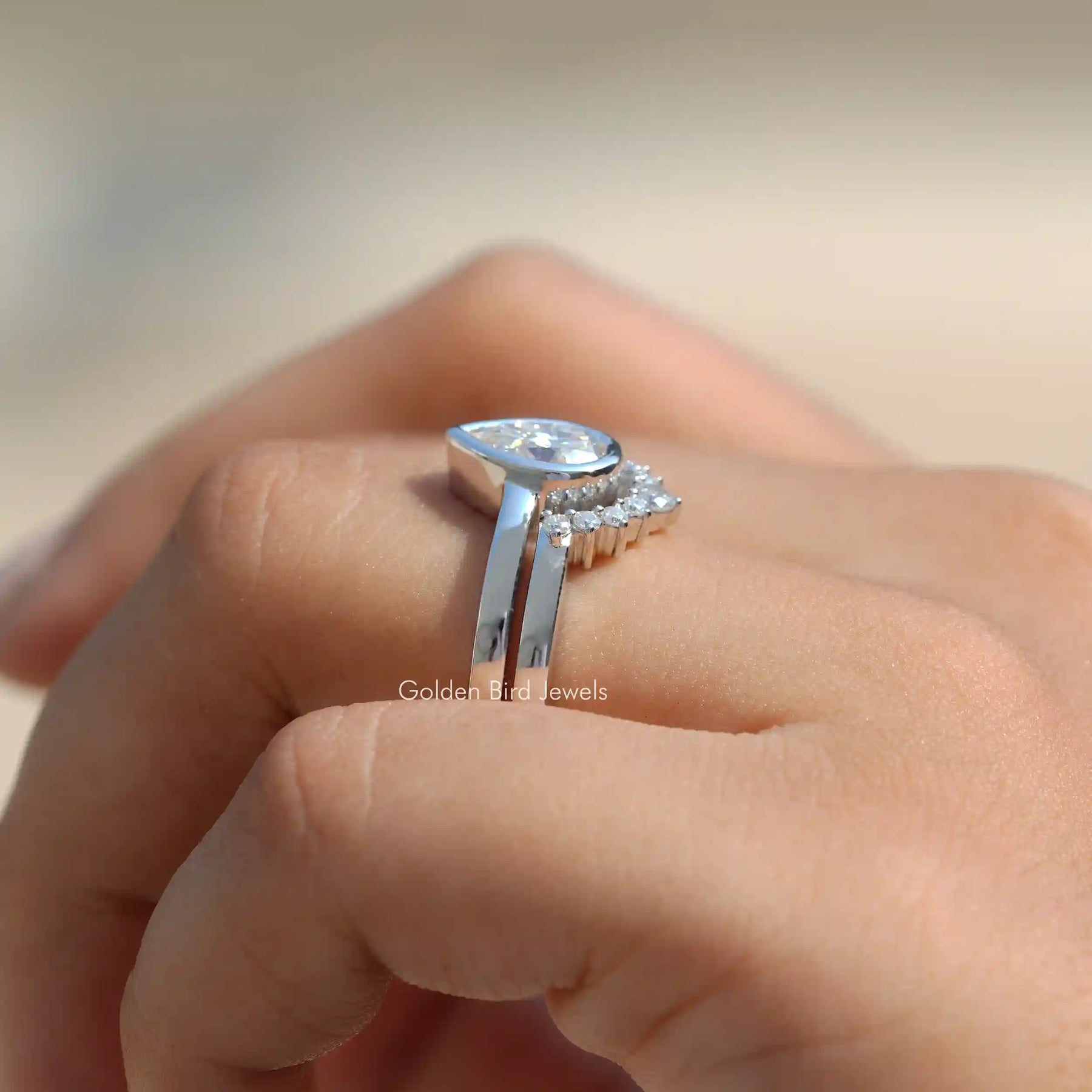 Side View of Pear Cut Moissanite Bridal Ring Set In finger
