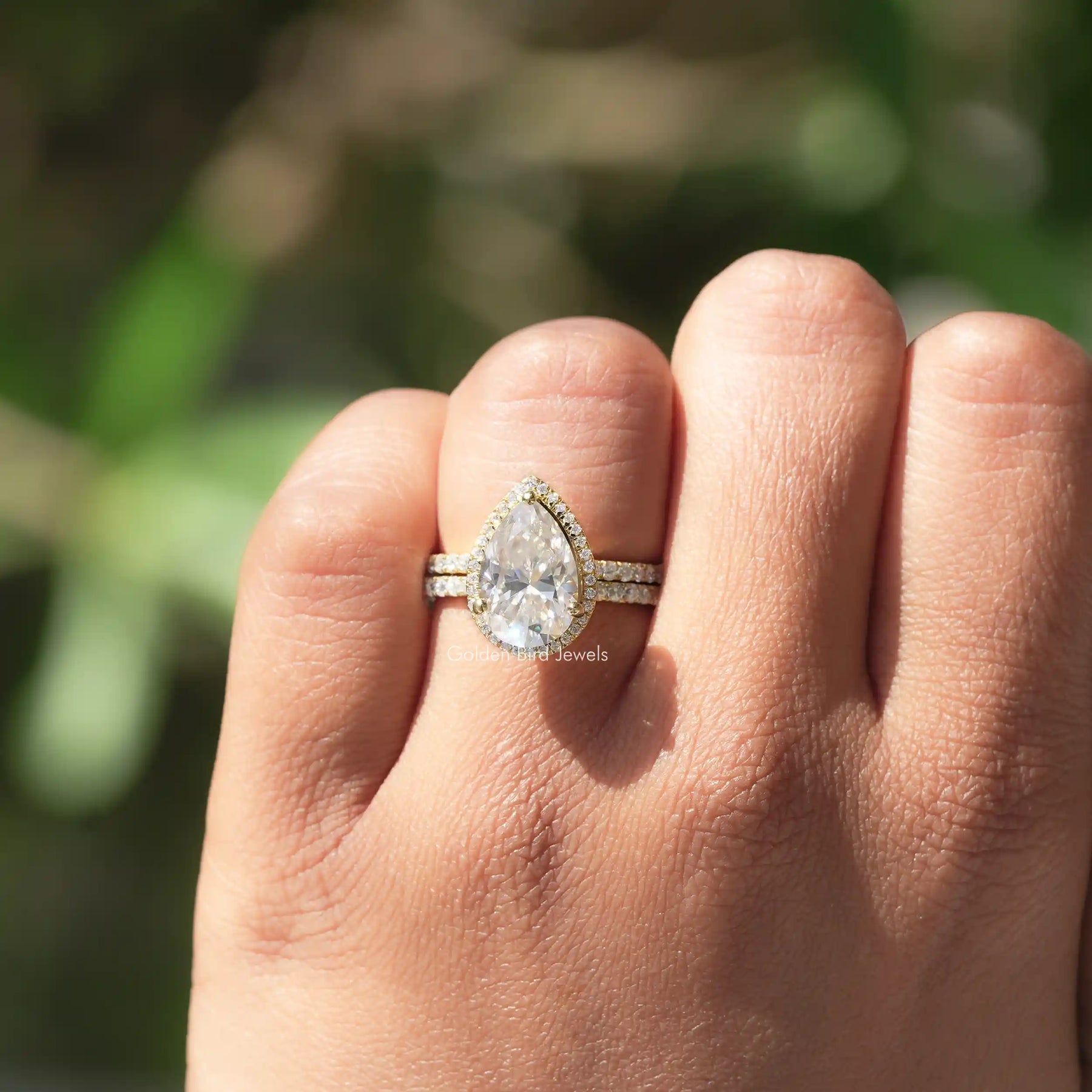 Pear Cut Moissanite Halo Engagement Ring In finger