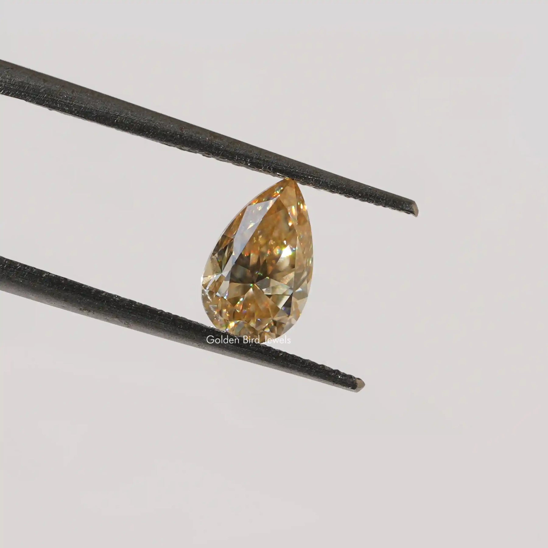 Twijer holding On Pear Cut Moissanite Loose Stone