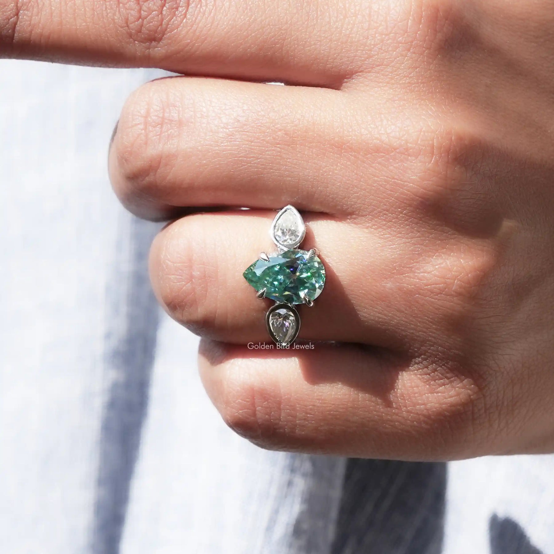 View of Pear Cut Moissanite Three Stone Ring In finger