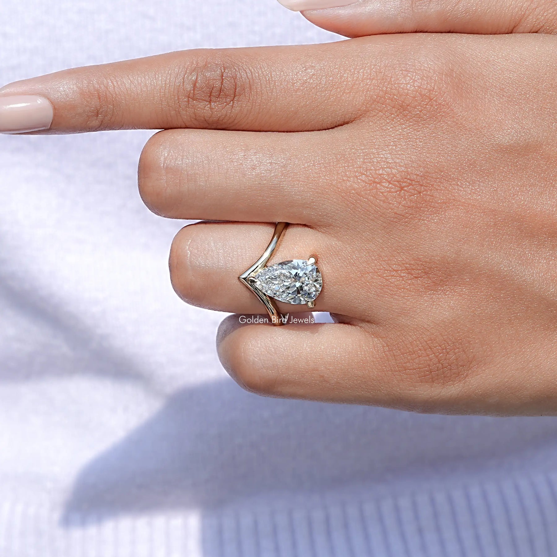Close-Up View of Pear Cut V Shape Solitaire Engagement Ring In Yellow Gold