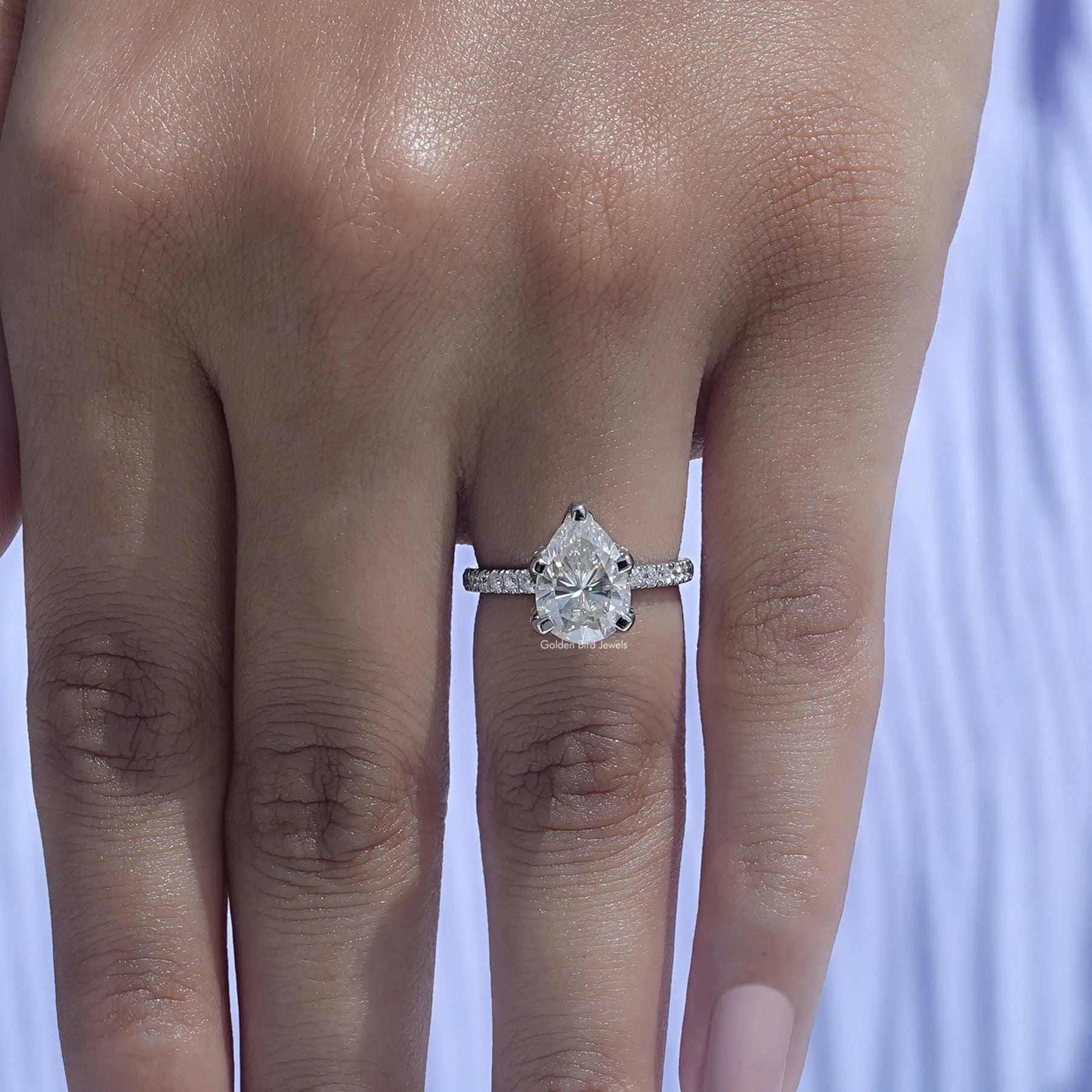 Close-Up View of Moissanite Pear Cut Engagement Ring In White Gold