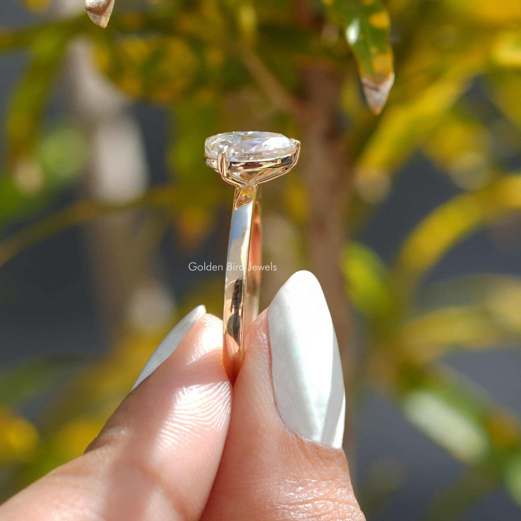 Side View of Pear And Princess Cut Toi Et Moi Ring In two fingers
