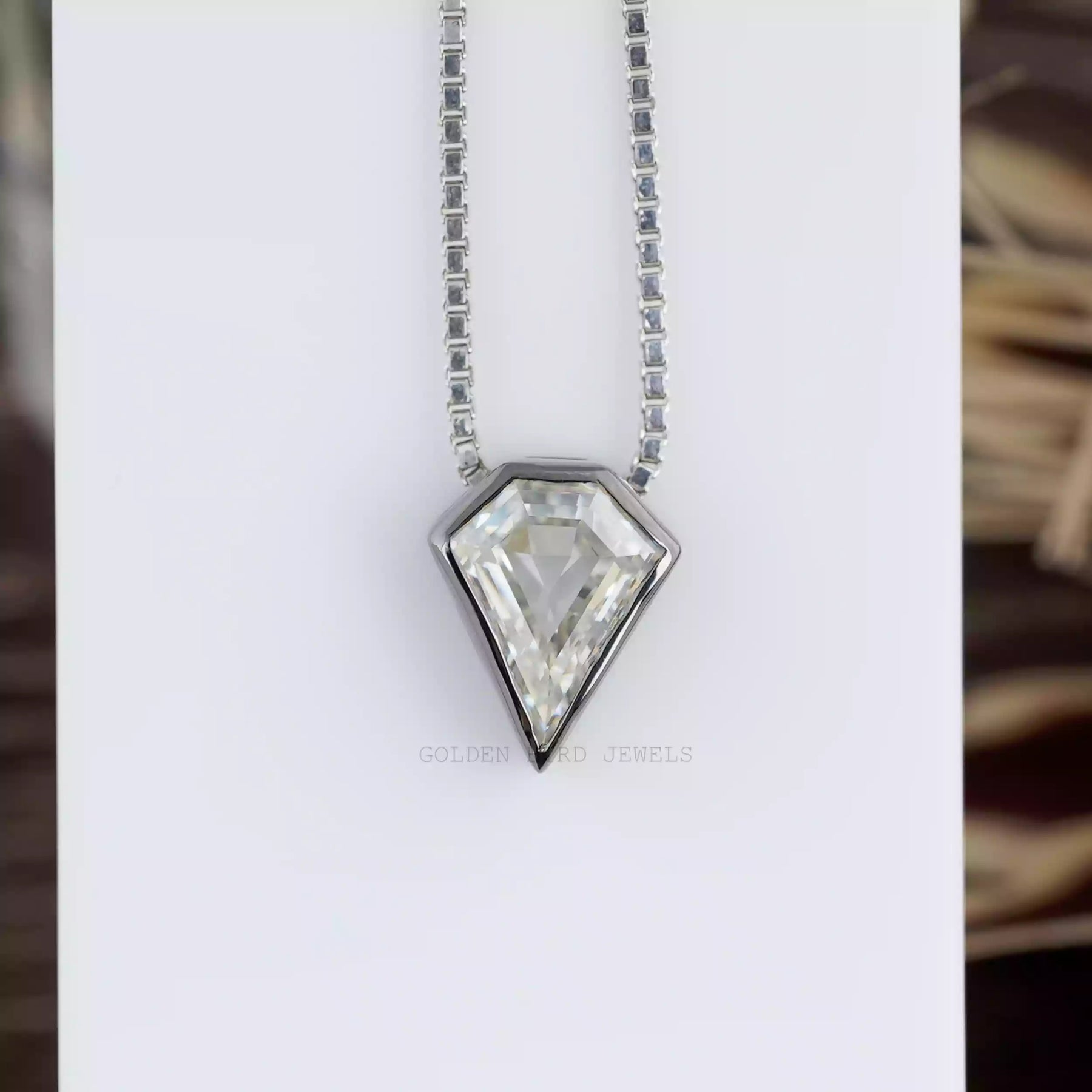 Front view of moissanite pendant crafted with bezel setting