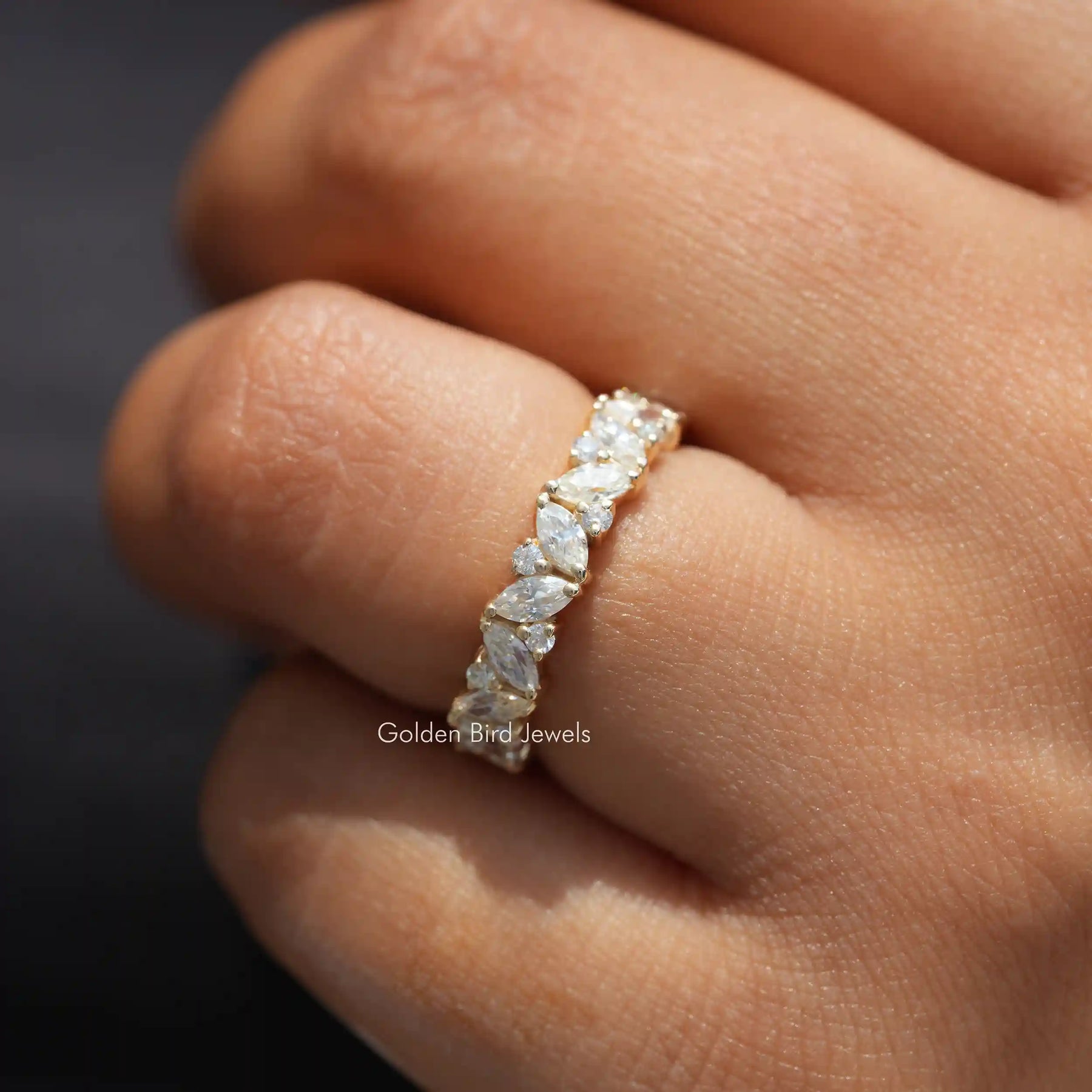 In finger front view of Marquise And Round Cut Moissanite engagement ring