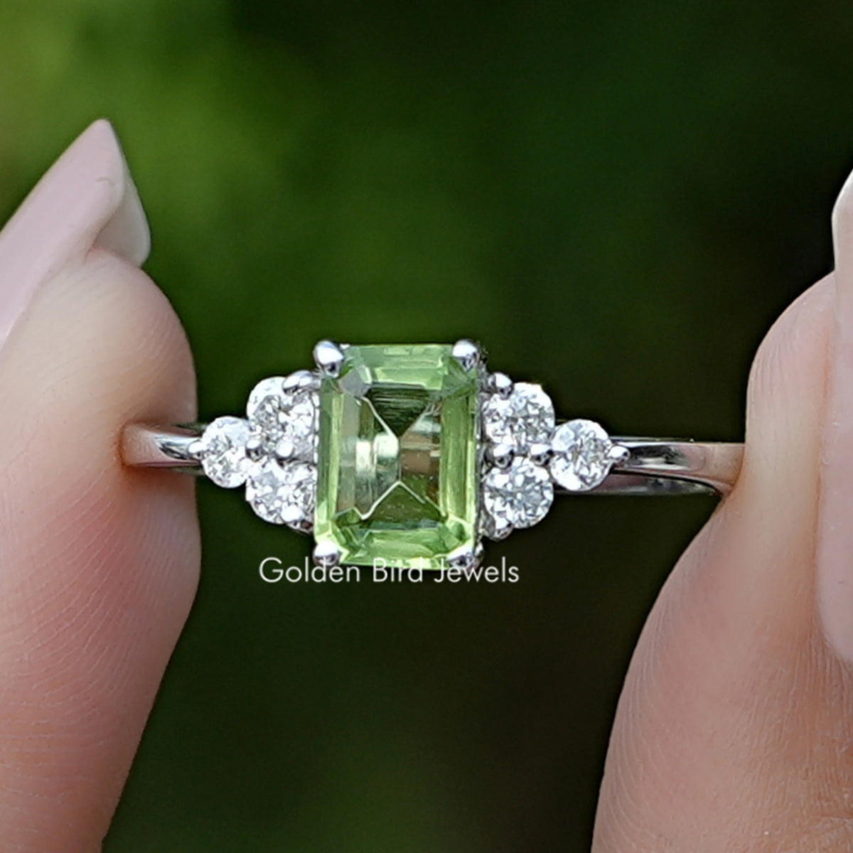 Front view of Peridot Green Emerald Gemstone Ring in two fingers