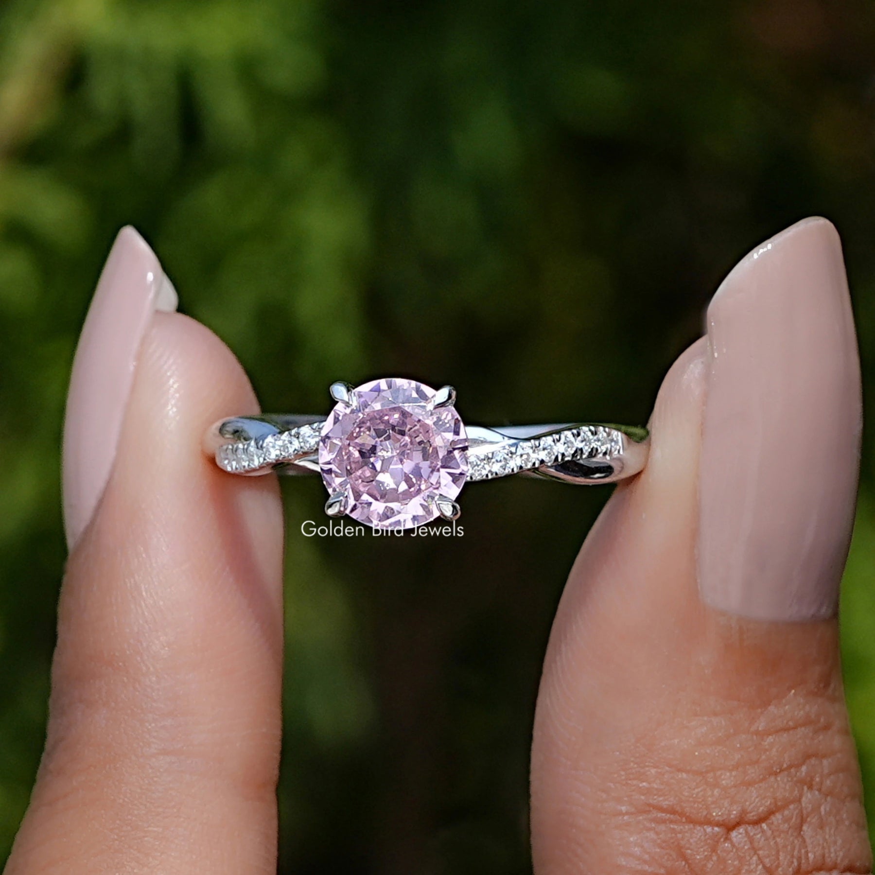 Front View of Tourmaline Round Cut Gemstone Accent Ring In two Fingers