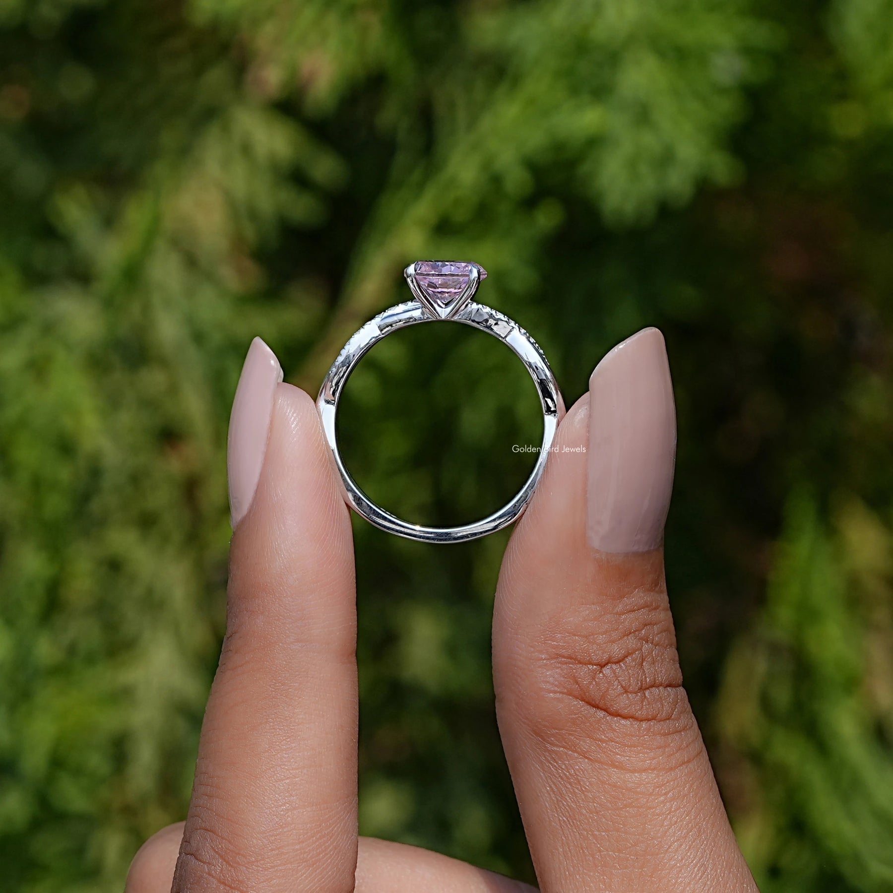 Back View of Pink Tourmaline Round Cut Gemstone Ring In two fingers