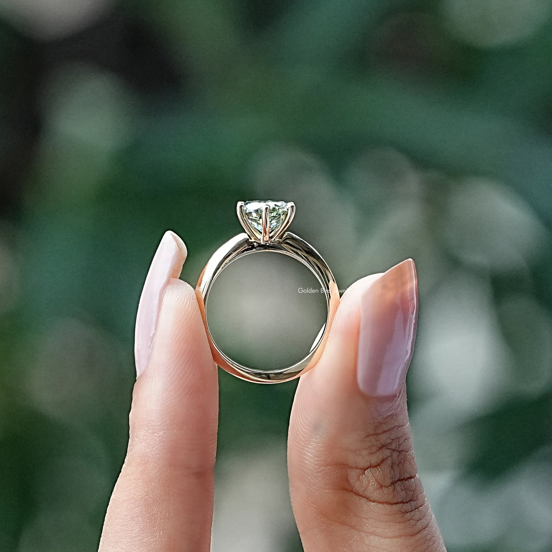Back View of Round Cut Moissanite Solitaire Ring In two fingers