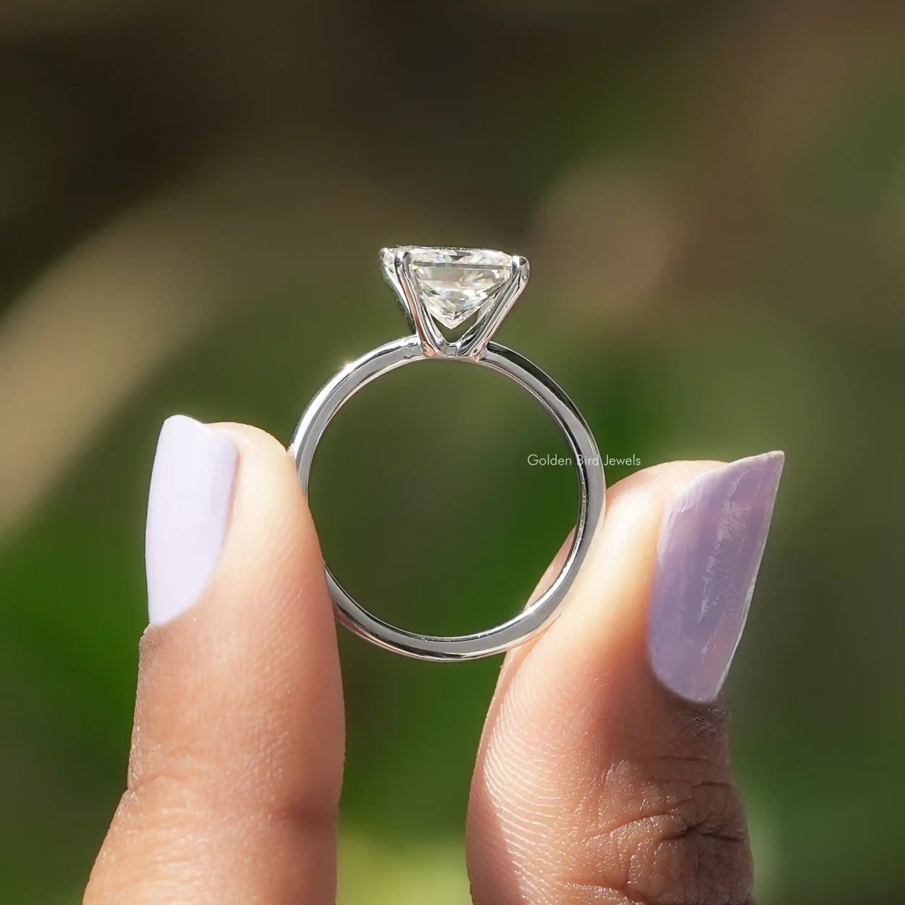 Back View of Princess Cut Moissanite Solitaire Ring In two fingers