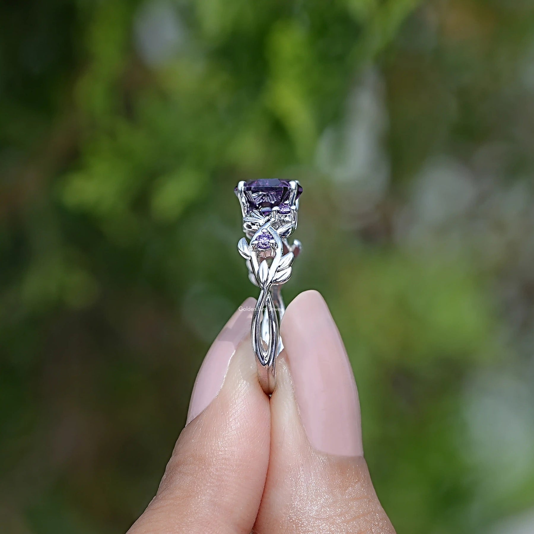 Side View of Hexagon Cut Leaf Engagement Ring In two fingers