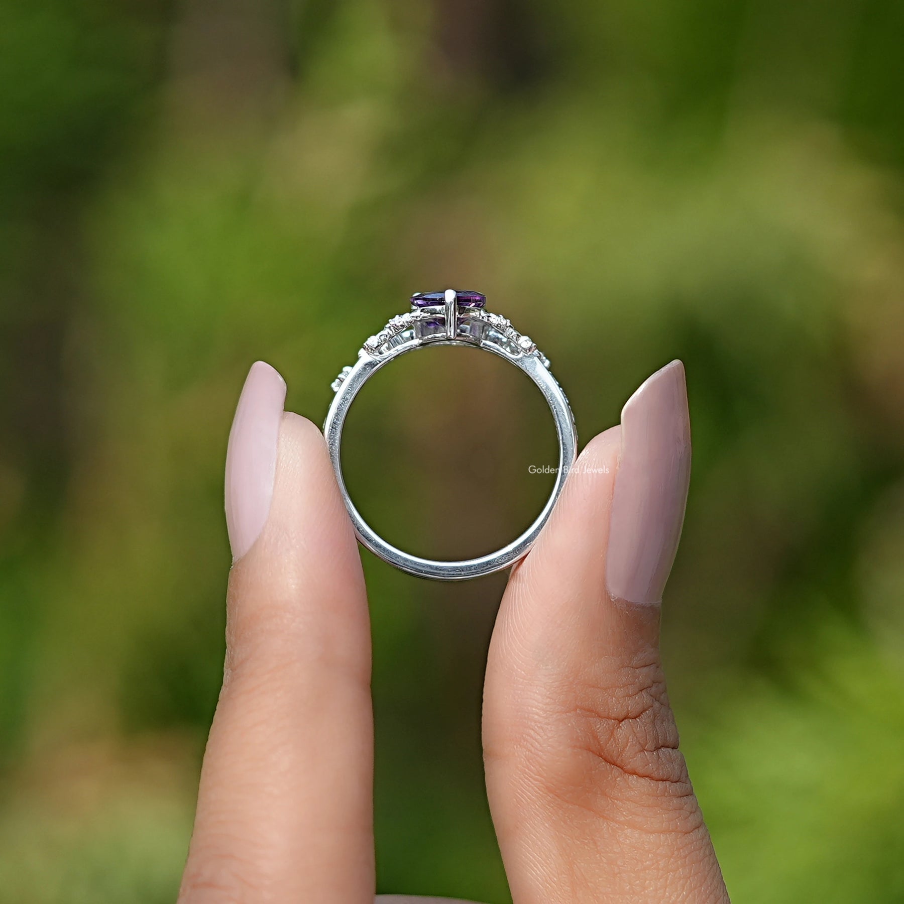 Back View of Purple Amethyst Pear Gemstone Accent Bridal Ring In two fingers