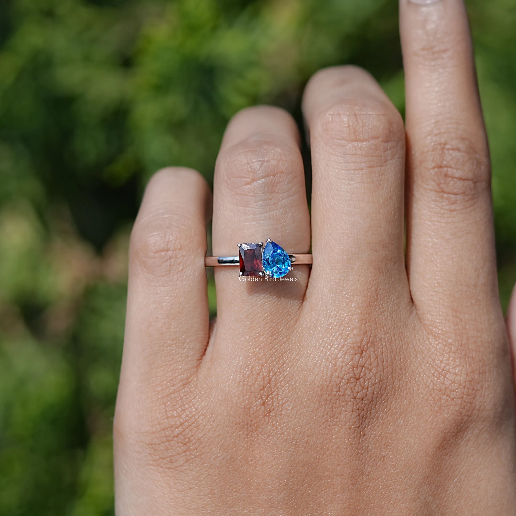 In finger front view of Two Stone Moissanite Engagement Ring