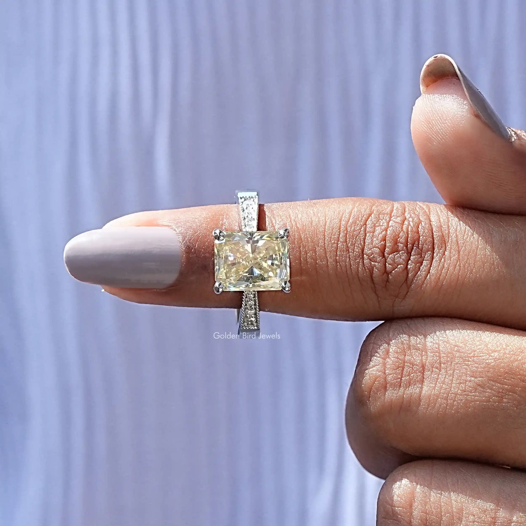 In finger front View of Moissanite Radiant Cut Accent Ring In White Gold