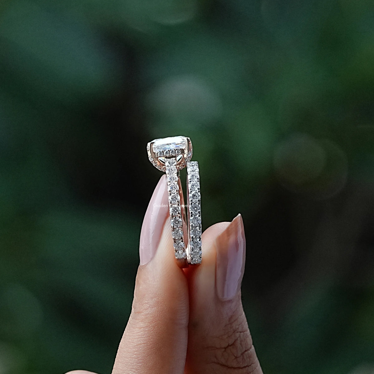 Side View of Radiant Cut Moissanite Bridal Ring Set In two fingers