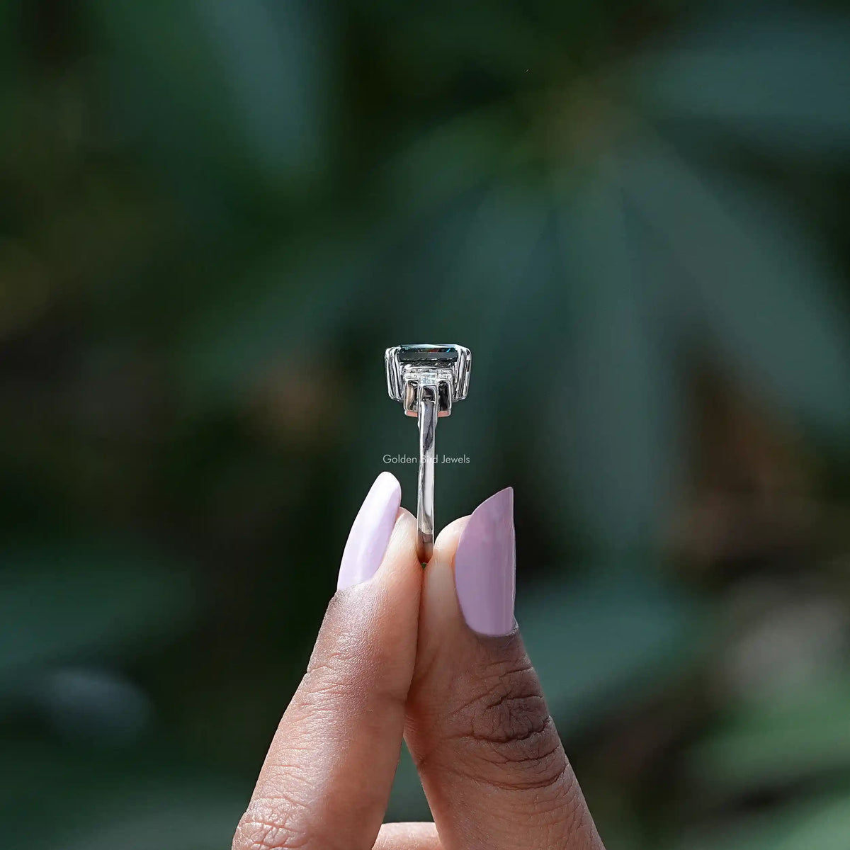 Side View of Radiant Cut Moissanite Engagement Ring In two fingers