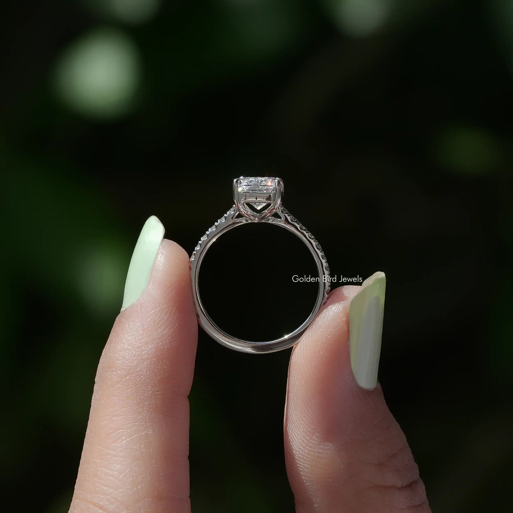 Back View of Radiant Cut Solitaire Accent Diamond Engagement Ring In two fingers