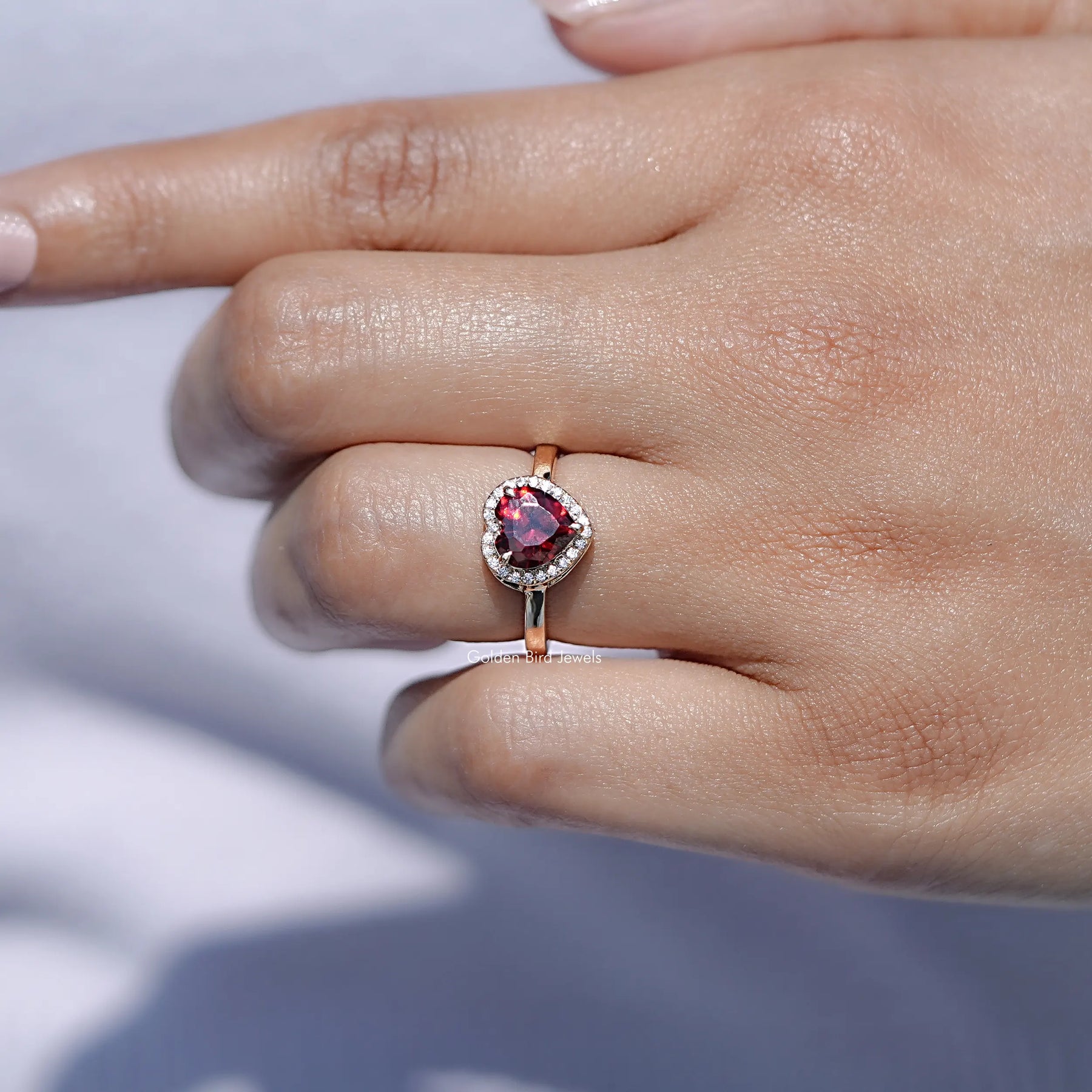 View of solitaire Red Ruby Heart ring in prongs setting