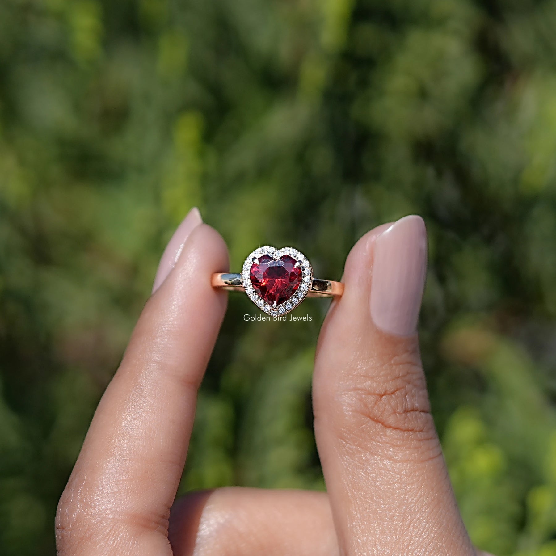 Front view of Ruby Heart Gemstone engagement ring holding in two fingers