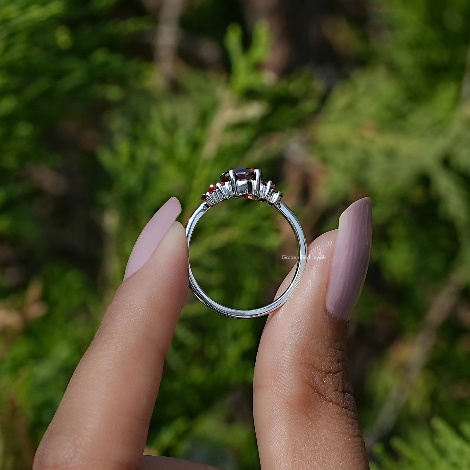 Back View of Hexagon Cut Gemstone 5 Stone Engagement Ring In two fingers