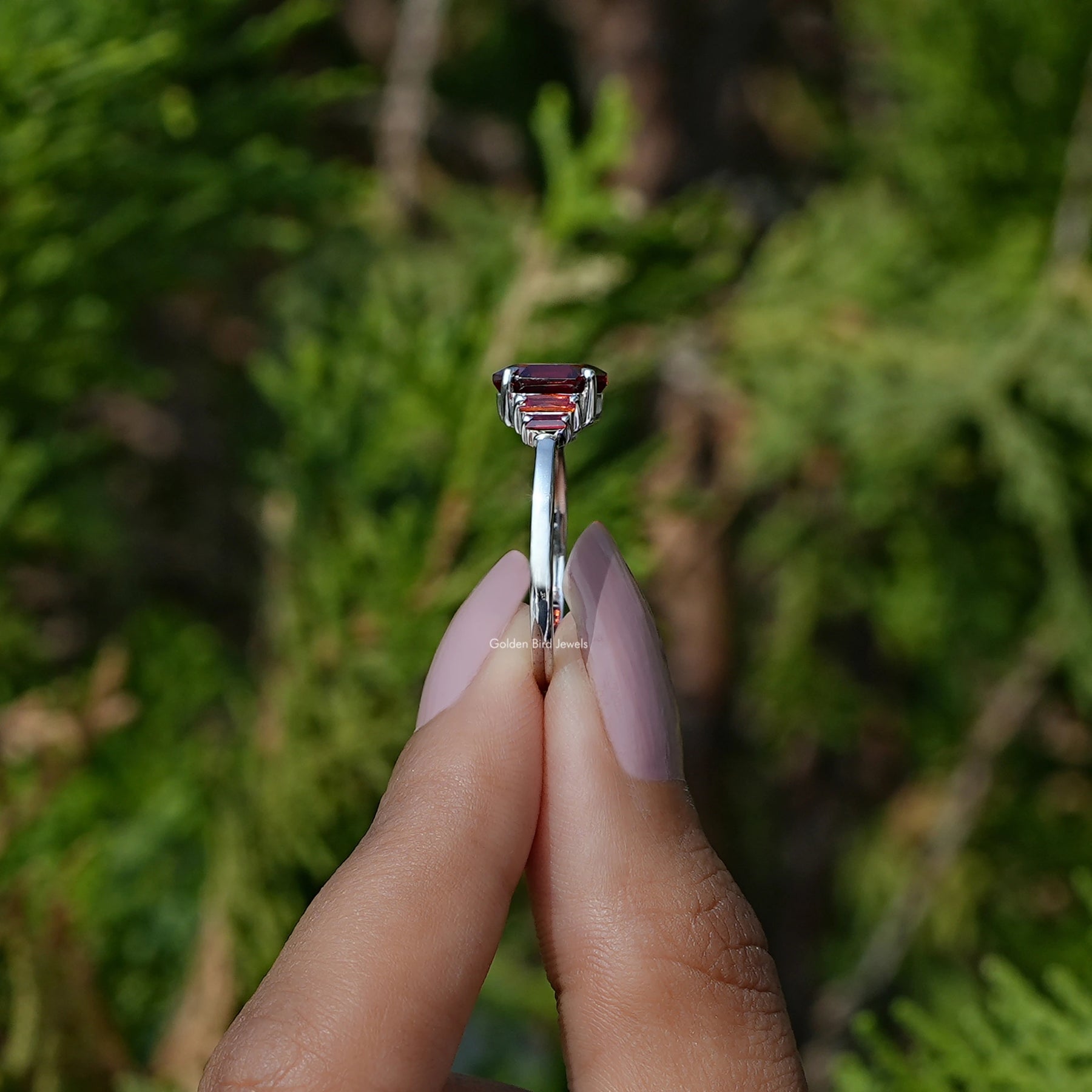Side View of Red Ruby Hexagon Cut Gemstone Ring In two fingers