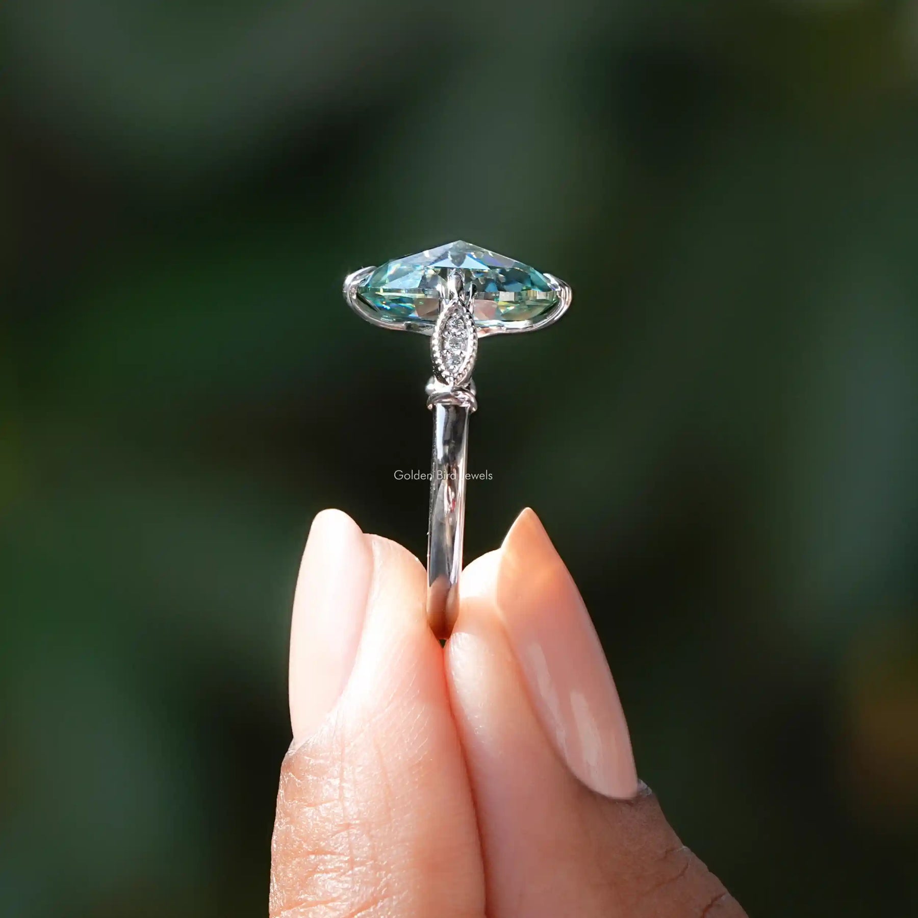 Rose gold oval cut moissanite accent ring, side view.