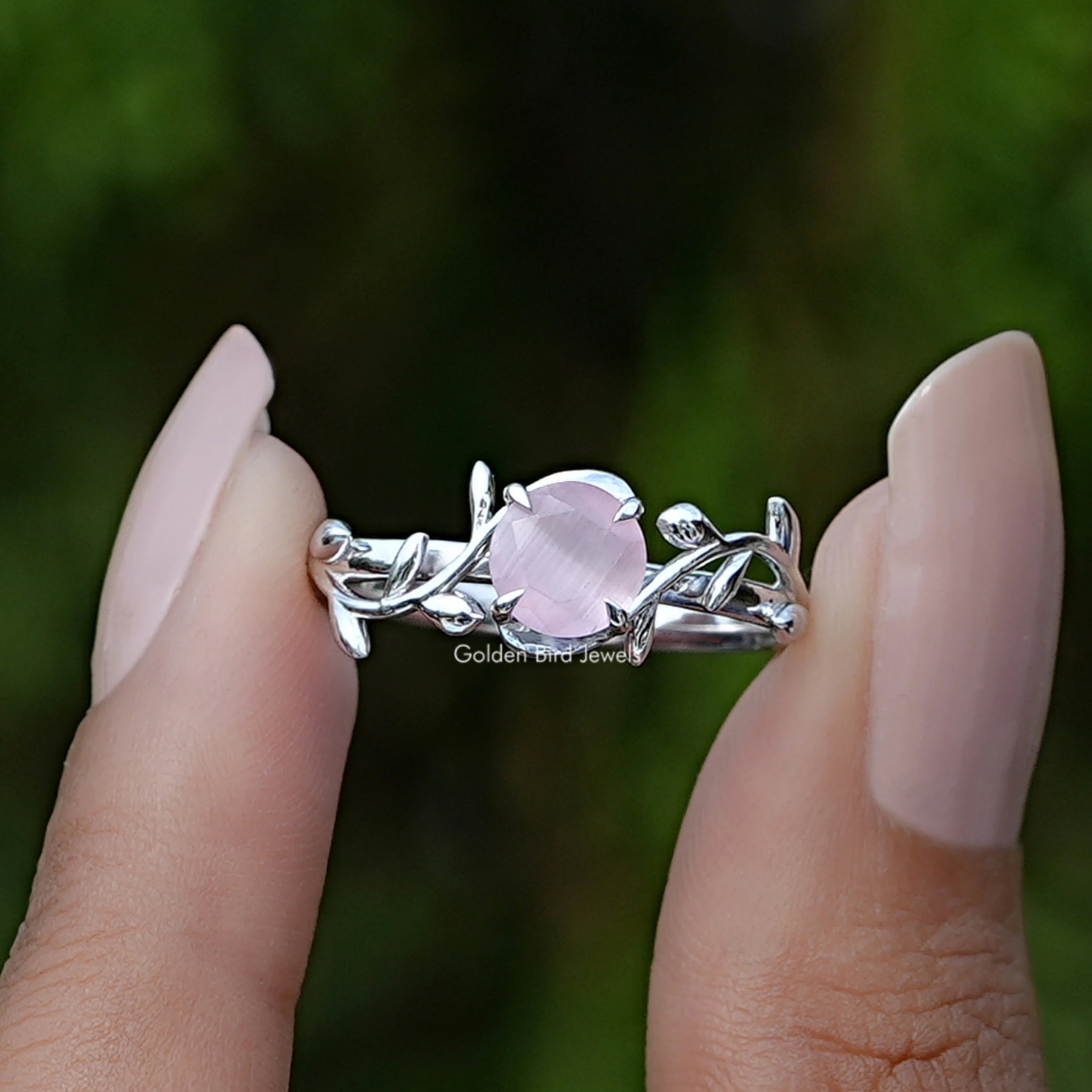 Front View of Rose Quartz Round Gemstone Leaf Style Ring In two Fingers