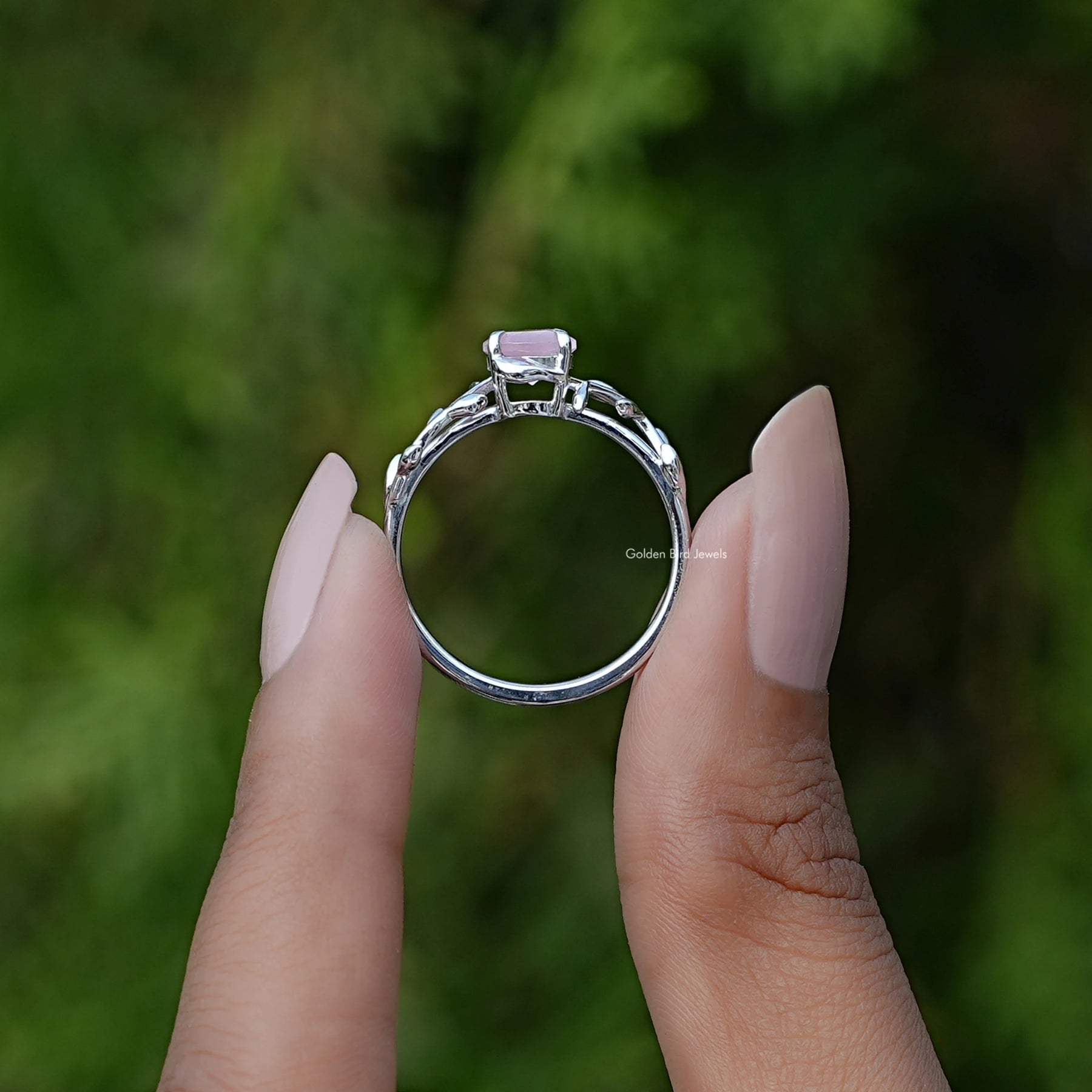 Back View of Round Gemstone Leaf Style Solitaire Ring In two fingers