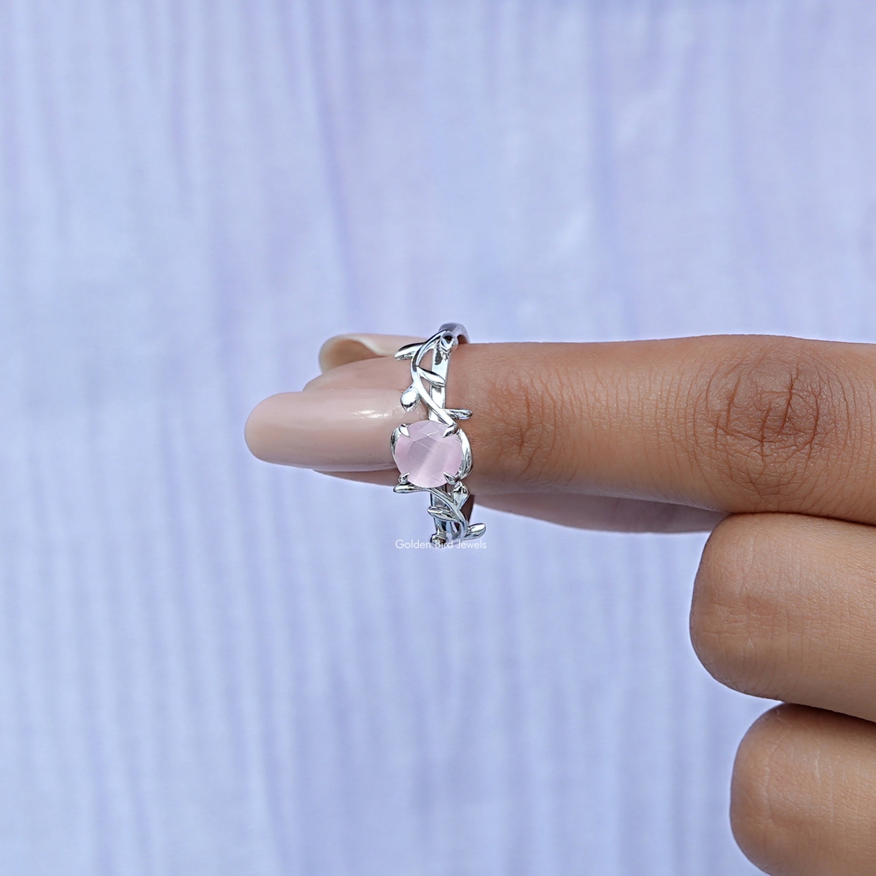 In finger front View of Round Cut Gemstone Leaf Style Ring In White Gold