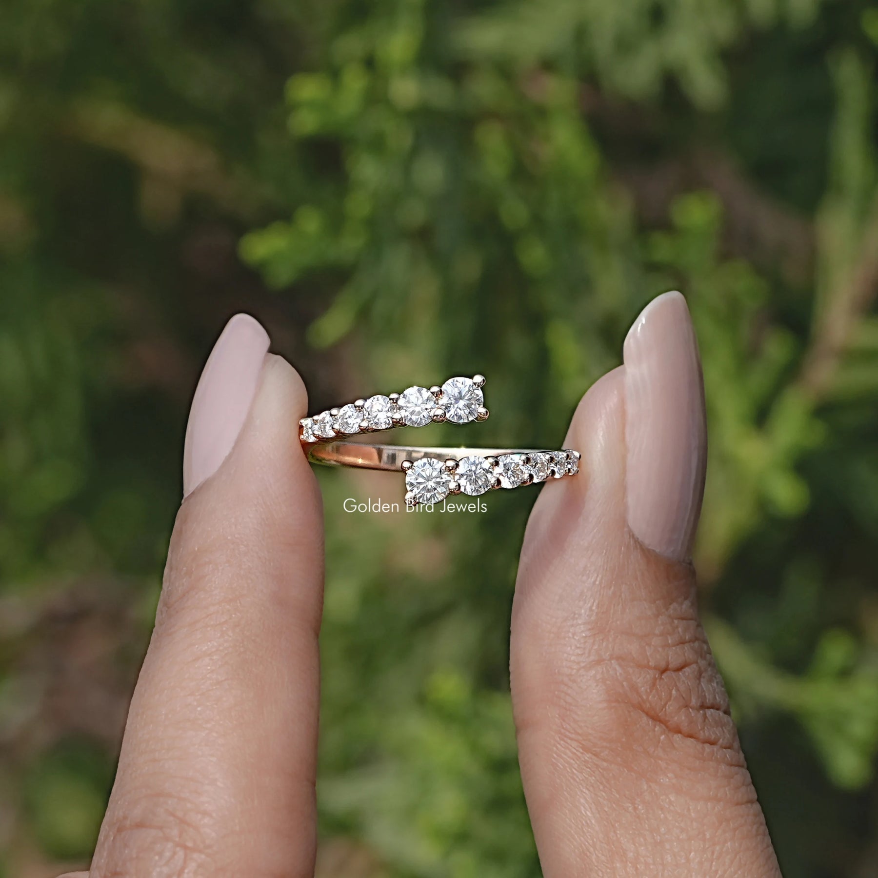 Front view of Round Cut Moissanite Open Wrap Bypass Ring in two fingers
