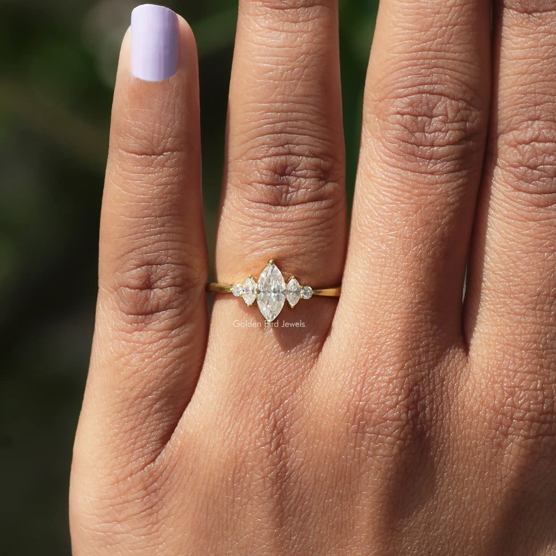 View of Marquise And Round Cut Engagement Ring In finger