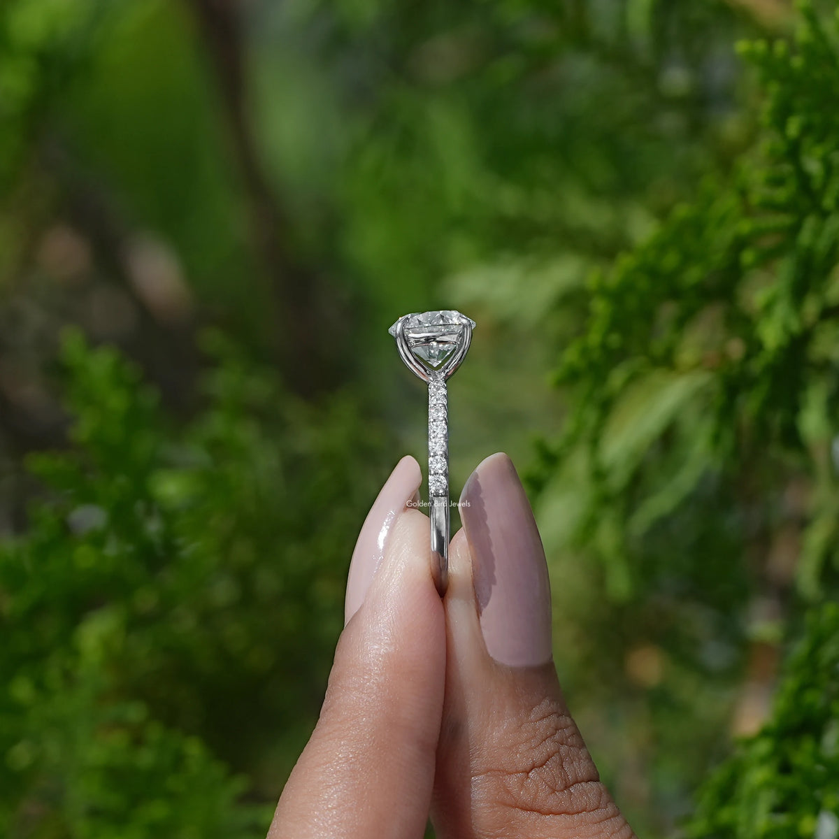 Side View of Round Cut Lab Grown Solitaire Ring In two fingers