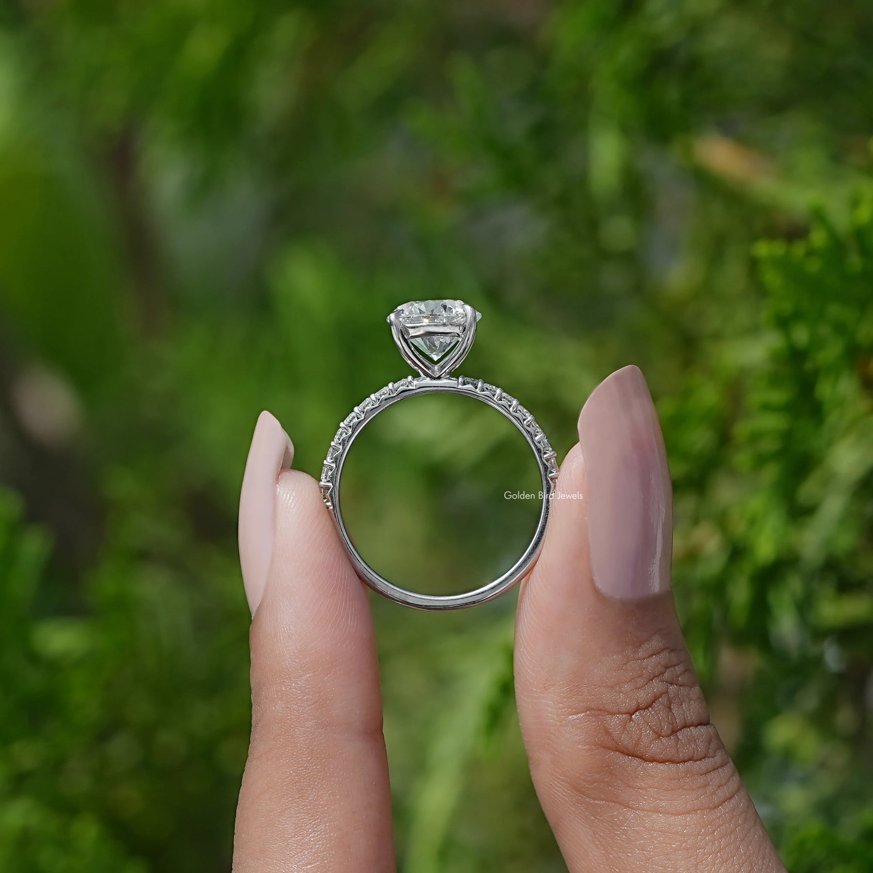 Back View of Round Cut Diamond Solitaire Accent Ring In two fingers