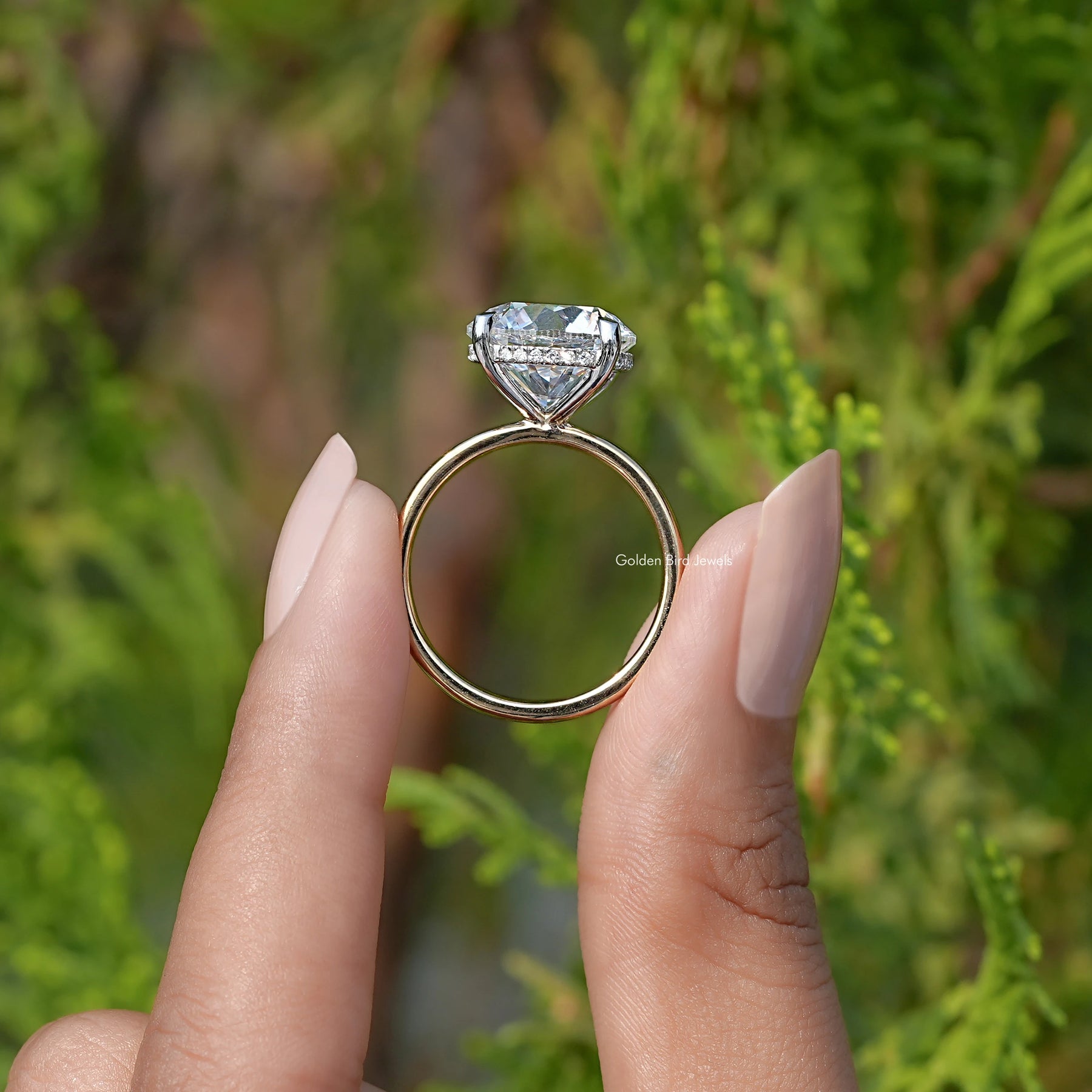 Back View of Round Cut Lab Diamond Hidden Halo Solitaire Ring In two fingers