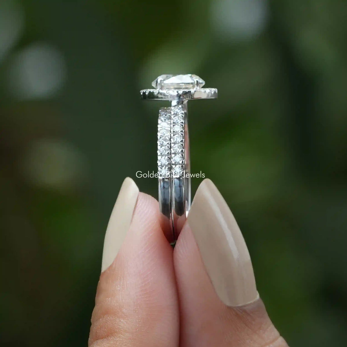 Side View of Round Halo Moissanite Engagement Ring In two fingers